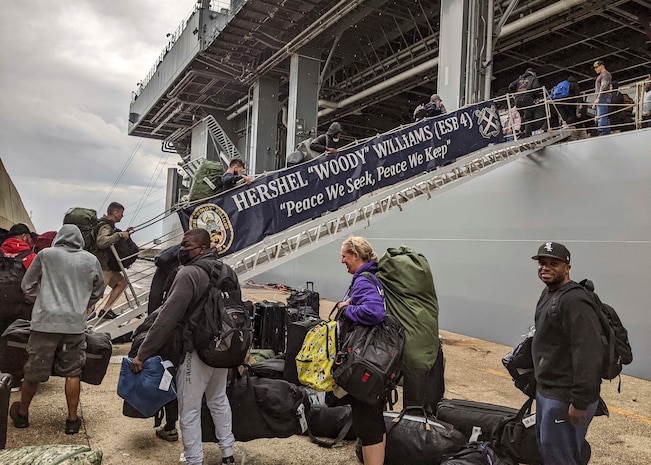 Sailors assigned to the Expeditionary Sea Base USS Hershel "Woody" Williams (ESB 4), BLUE military crew, move aboard to conduct a exchange of command with the Gold military crew, May 8, 2022. Hershel "Woody" Williams is on a scheduled deployment in the U.S. Sixth Fleet area of operations in support of U.S. national interests and security in Europe and Africa.