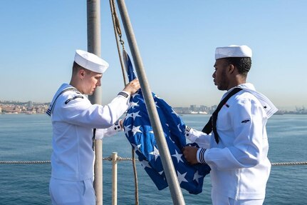 220510-N-DN159-1034 NAPLES, Italy (May 10, 2022) Electronics Technician 3rd Class Brian Tarnalicki, from Baltimore, left, and Aviation Boatswain's Mate (Equipment) Airman Jahcobi Edmonds, from Valdosta, Georgia, raise the Union Jack on the flight deck of the Nimitz-class aircraft carrier USS Harry S. Truman (CVN 75) as the ship pulls into Naples, Italy for a scheduled port visit, May 10, 2022. The Harry S. Truman Carrier Strike Group is on a scheduled deployment in the U.S. Sixth Fleet area of operations in support of U.S., Allied and partner interests in Europe and Africa. (U.S. Navy photo by Mass Communication Specialist 3rd Class Crayton Agnew)