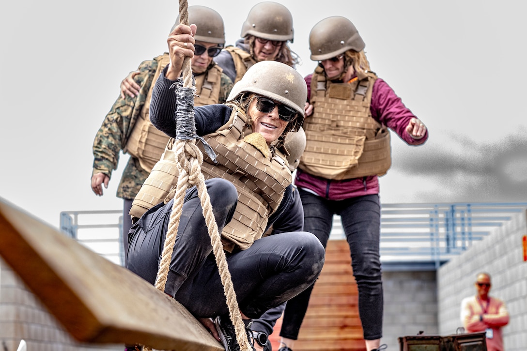 Educators work together to complete a team building exercise during the U.S. Marine Corps Educators' Workshop at Marine Corps Base Camp Pendleton, California on March 31, 2022. The Educators' Workshop is a five-day program designed to better inform teachers, coaches, counselors and influencers about the benefits and opportunities available during service in the Marine Corps. This allows attendees to return home and provide firsthand experience and knowledge to individuals interested in military service. (U.S. Marine Corps photo by Staff Sgt. Kelsey Dornfeld)