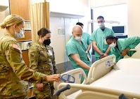 Airman 1st Class Madelyn Lonczak, 104th Medical Group aerospace medical technician and Tripler Army Medical Center staff learn the functions on a hospital bed at TAMC, Hawaii, April 28, 2022. Lonczak is at Tripler to provide medical support and complete training requirements. (U.S. Air National Guard Photo by Senior Airman Camille Lienau)