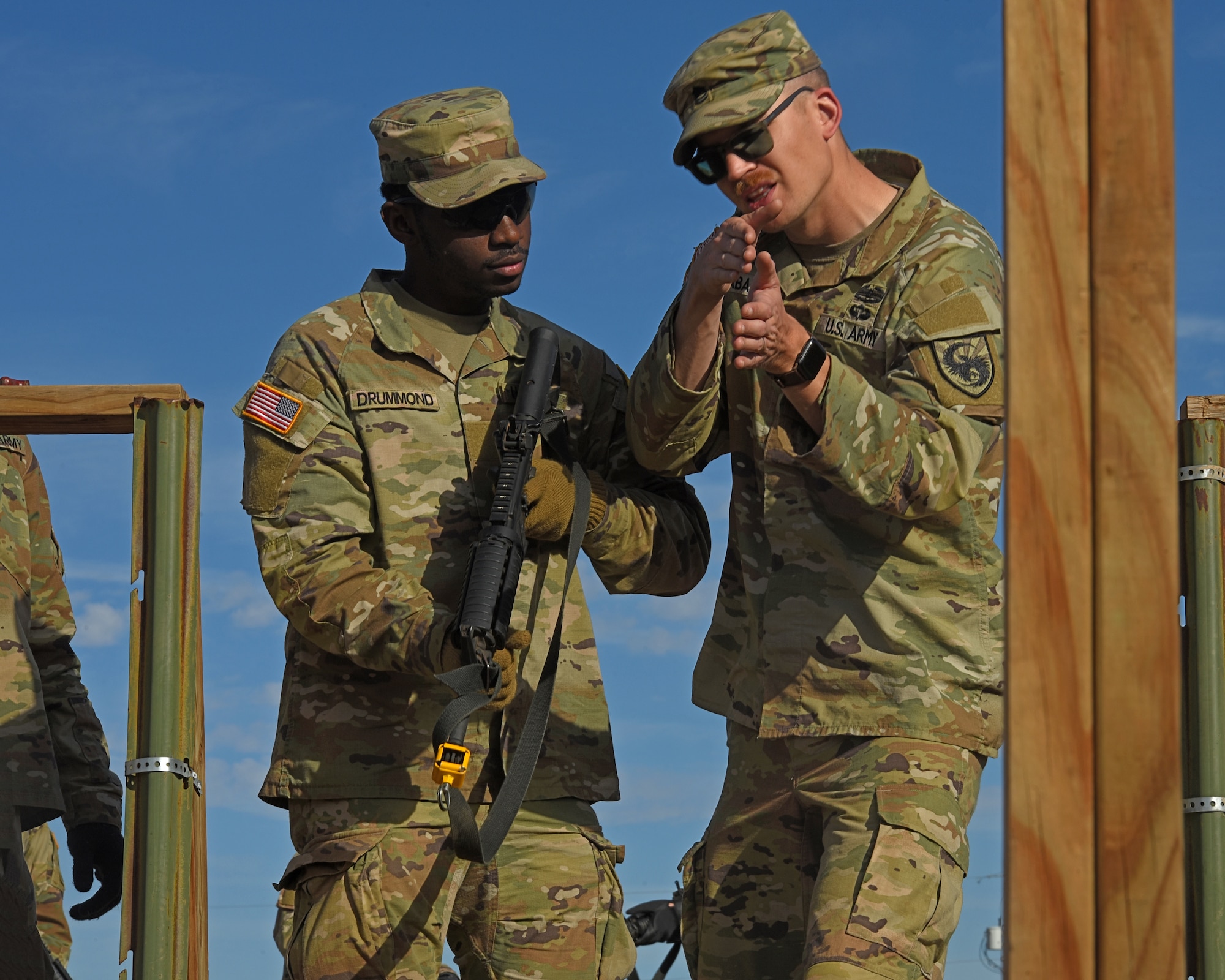 U.S. Army Sgt. First Class Ryan Slabaugh, 344th Military Intelligence Battalion instructor, explains room clearing strategy to Pvt. Joshua Drummond, during the joint capstone assessment at Goodfellow Air Force Base, Texas, Feb. 1, 2022. The 17th Training Wings ensures joint service military members develop and hone their skills by utilizing realistic hands-on training tactics. (U.S. Air Force Photo by Senior Airman Abbey Rieves)