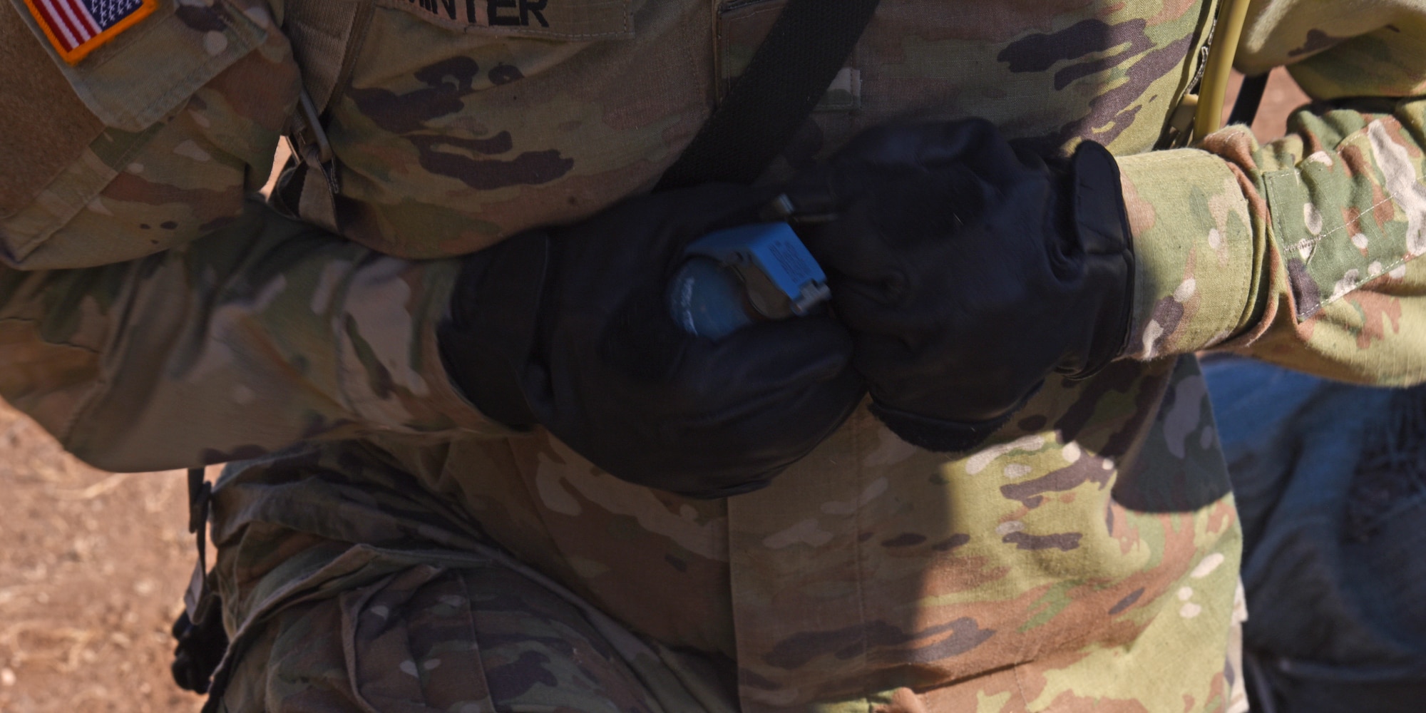 A U.S. Army student assigned to the 344th Military Intelligence Battalion, pulls the pin from a mock grenade during a joint capstone assessment at Goodfellow Air Force Base, Texas, Feb. 1, 2022. The Tactical Signals Intelligence exercise was located at Forward Operating Base Sentinel, which was a mock environment with simulated adversary-enhanced components. (U.S. Air Force Photo by Senior Airman Abbey Rieves)