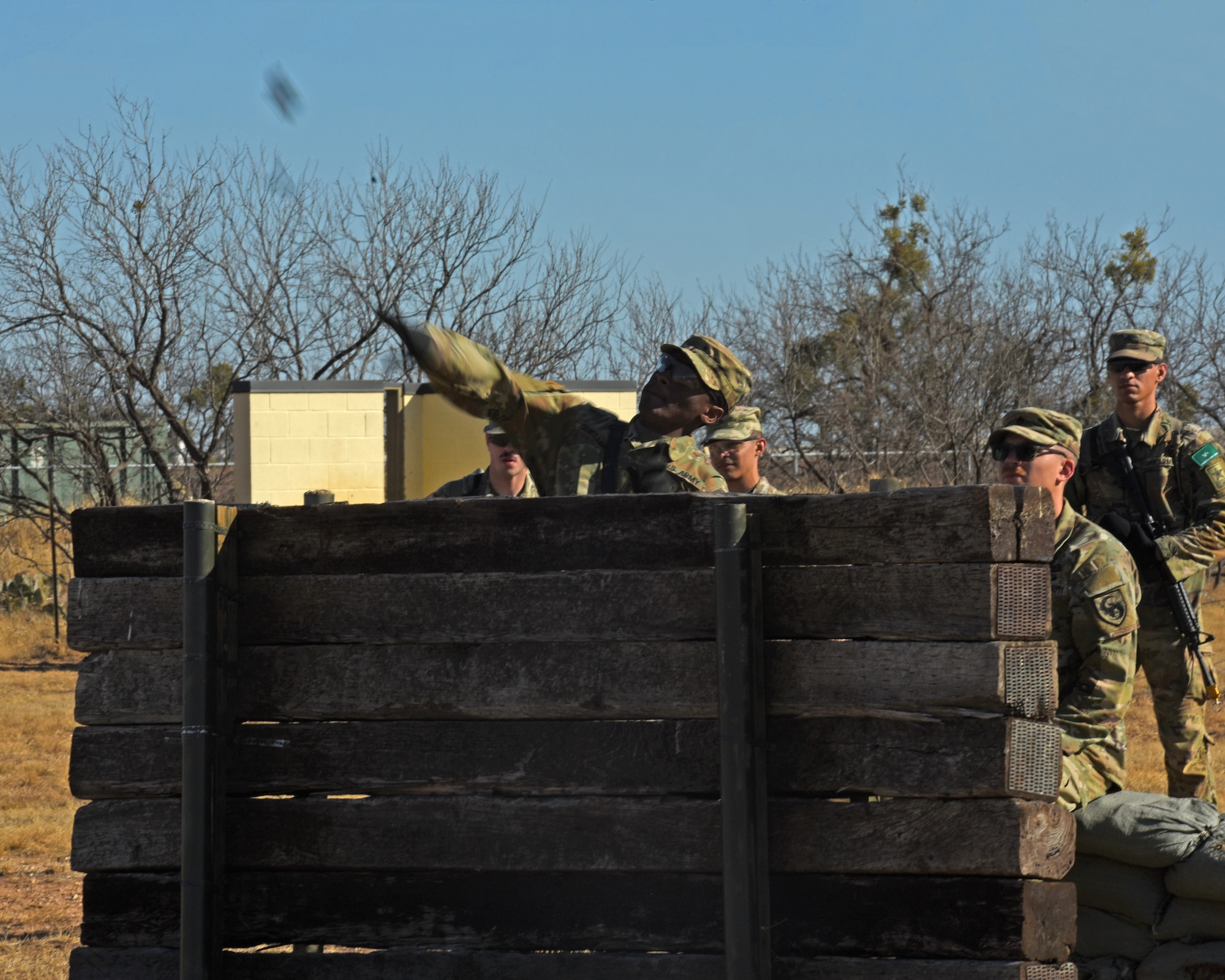 A U.S. Army student assigned to the 344th Military Intelligence Battalion, throws a mock grenade during a joint capstone assessment at Goodfellow Air Force Base, Texas, Feb. 1, 2022. Capstone training like this epitomizes how the 17th Training Wing builds joint coalition warriors. (U.S. Air Force Photo by Senior Airman Abbey Rieves)