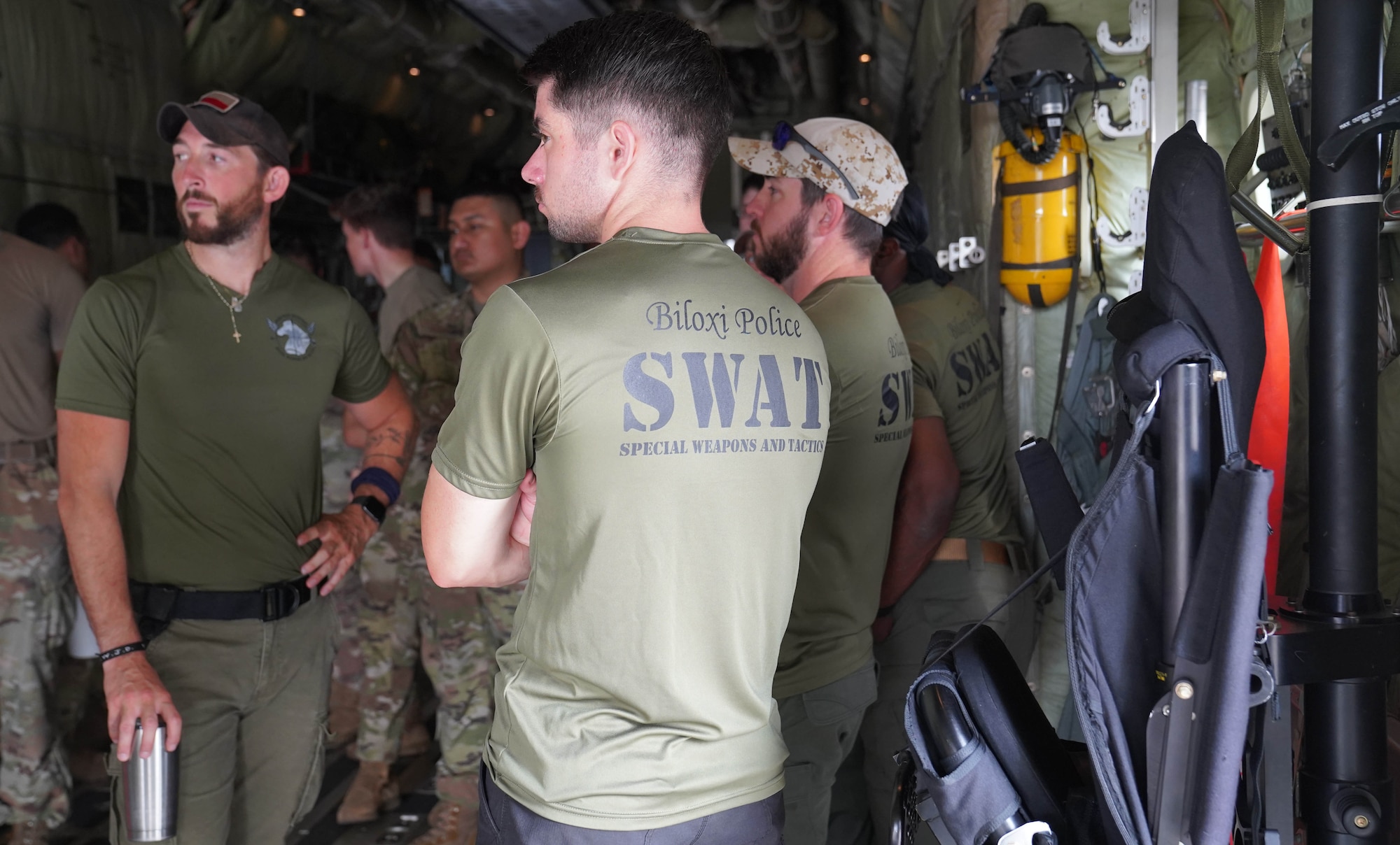 Nathan Lamberth and Steven Kinsey, Biloxi Special Weapons and Tactics officers, participate in a joint training with the 81st Security Forces Squadron aboard a C-130 at Keesler Air Force Base, Mississippi, May 9, 2022. Security forces and Biloxi SWAT members trained together on aircraft anti-hijacking procedures.