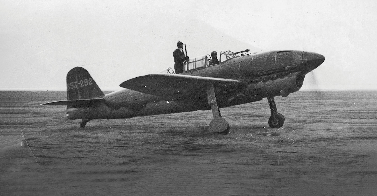 The Judy came in two versions that used two different power plants. While the D4Y3, shown in the cover illustration, used a Japanese designed air-cooled radial engine, the earlier D4Y2 used a liquid-cooled vee engine as shown here. As with many aircraft with such an engine, the aircraft’s design required a long nose which often restricted the pilot’s view forward, hence the standing observer helps the pilot taxi. (Photo courtesy of Tony Holmes Collection)