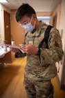 Senior Airman Tenzin Dakar, 104th Medical Group aerospace medical technician, looks over a spreadsheet during a training exercise at Tripler Army Medical Center, Hawaii, April 28, 2022. Dakar is at Tripler to provide medical support and complete training requirements. (U.S. Air National Guard photo by 1Lt. Amelia Leonard)