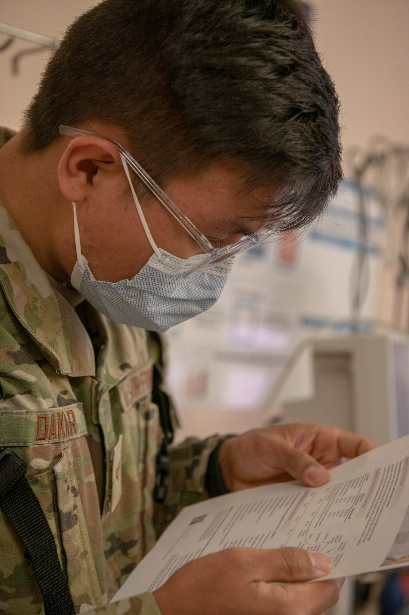 Senior Airman Tenzin Dakar, 104th Medical Group aerospace medical technician. looks over a spreadsheet during a training exercise at Tripler Army Medical Center, Hawaii, April 28, 2022. Dakar is at Tripler to provide medical support and complete training requirements. (U.S. Air National Guard photo by 1Lt. Amelia Leonard)