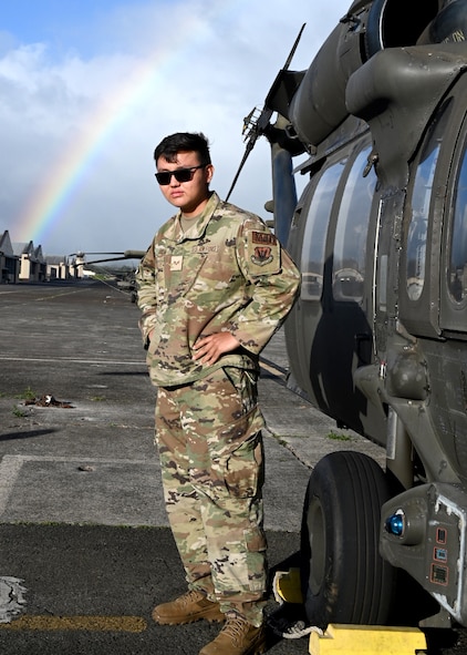 Senior Airman Tenzin Dakar, 104th Medical Group Aerospace medical technician, stands in front of an Army UH-60 Black Hawk helicopter after a morale flight at Wheeler Army Airfield, Hawaii, May 3, 2022. Dakar received the morale flight after completing training requirements at Tripler Army Medical Center. (U.S. Air National Guard Photo by Senior Airman Camille Lienau)