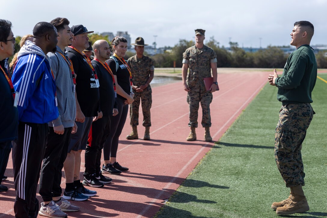 U.S. Marine Corps Staff Sgt. Andre Velez, a chief drill instructor with Receiving Company, Recruit Training Regiment, explains the Marine Corps Combat Fitness Test to educators  during the U.S. Marine Corps Educators' Workshop at Marine Corps Recruit Depot San Diego, California on March 29, 2022. The Educators' Workshop is a five-day program designed to better inform teachers, coaches, counselors and influencers about the benefits and opportunities available during service in the Marine Corps. This allows attendees to return home and provide firsthand experience and knowledge to individuals interested in military service. (U.S. Marine Corps photo by Staff Sgt. Kelsey Dornfeld)