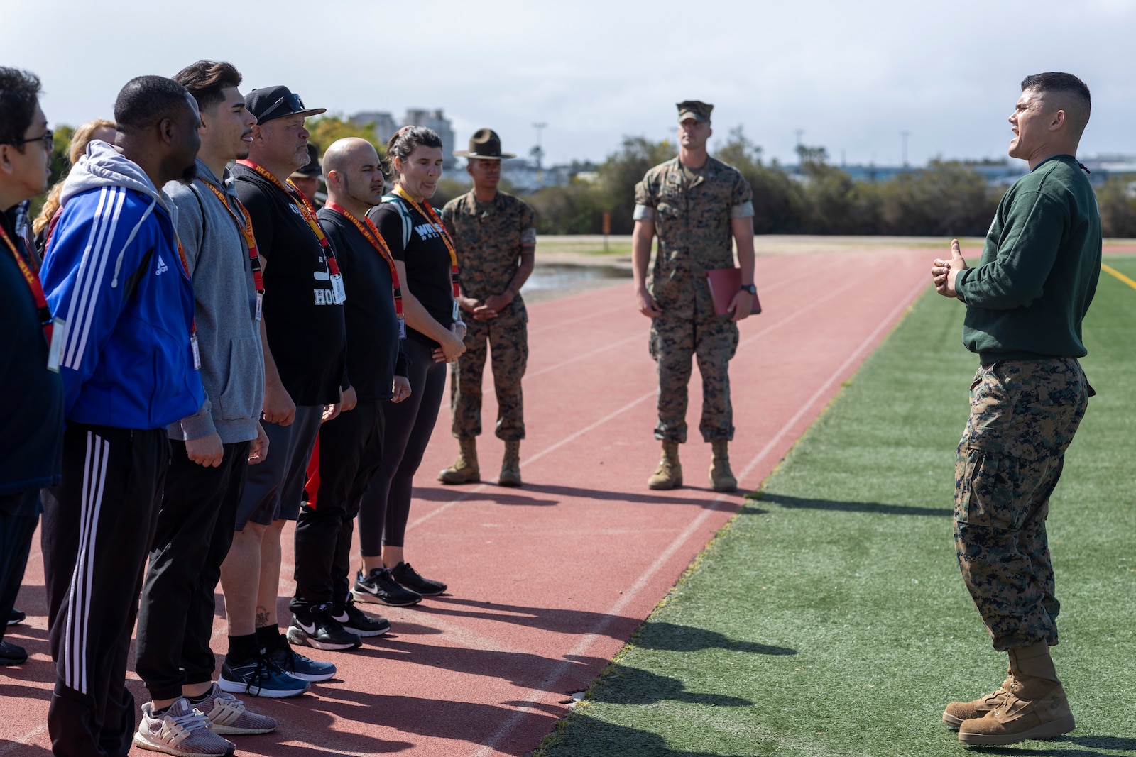 U.S. Marine Corps Staff Sgt. Andre Velez, a chief drill instructor with Receiving Company, Recruit Training Regiment, explains the Marine Corps Combat Fitness Test to educators  during the U.S. Marine Corps Educators' Workshop at Marine Corps Recruit Depot San Diego, California on March 29, 2022. The Educators' Workshop is a five-day program designed to better inform teachers, coaches, counselors and influencers about the benefits and opportunities available during service in the Marine Corps. This allows attendees to return home and provide firsthand experience and knowledge to individuals interested in military service. (U.S. Marine Corps photo by Staff Sgt. Kelsey Dornfeld)