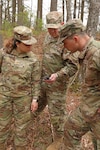 From left, 2nd Lt. Dayhna Marti-Ojeda, 2nd Lt. Jonathan Bascom and Sgt. Jesse Gillis, New Hampshire National Guard, check their GPS signal and coordinates during volunteer search and rescue training held at the Edward Cross training Complex  in Pembroke, New Hampshire, on May 7, 2022. Guardsmen will comprise a regional Volunteer Search and Rescue Team, formed in partnership with N.H. Fish and Game Department.