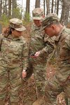 From left, 2nd Lt. Dayhna Marti-Ojeda, 2nd Lt. Jonathan Bascom and Sgt. Jesse Gillis, New Hampshire National Guard, check their GPS signal and coordinates during volunteer search and rescue training held at the Edward Cross training Complex  in Pembroke, New Hampshire, on May 7, 2022. Guardsmen will comprise a regional Volunteer Search and Rescue Team, formed in partnership with N.H. Fish and Game Department.