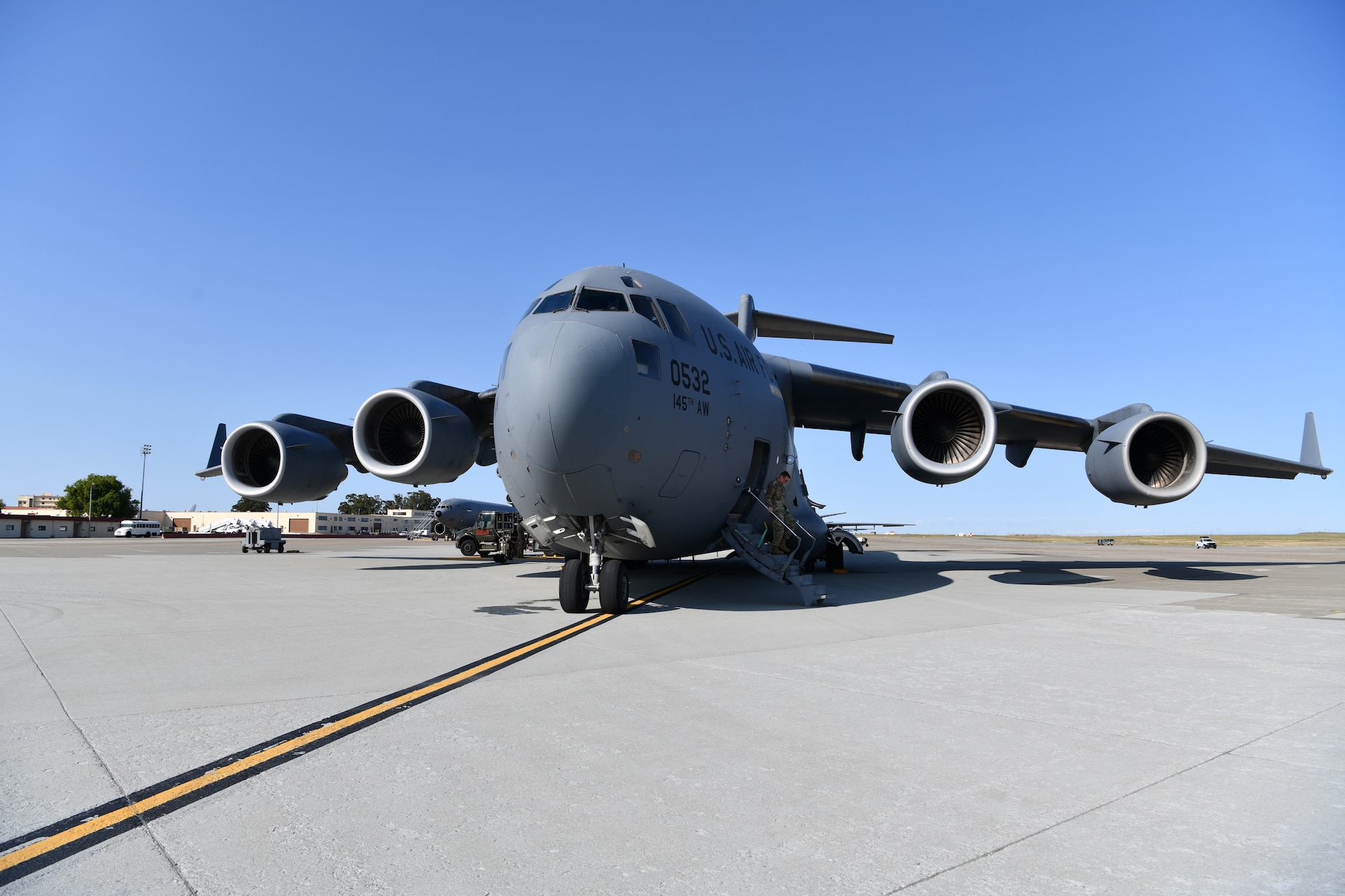 A C-17 Globemaster III from the 145th Airlift Wing in Charlotte, North Carolina waits on the flightline to be refueled at Travis Air Force Base, California, April 23, 2022. The C-17 was used to transport Airmen from the 104th Fighter Wing and 174th Attack Wing to Honolulu, Hawaii and is the U.S. Air Force's primary strategic lift aircraft. (U.S. Air National Guard Photo by Senior Airman Camille Lienau)