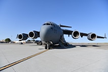 A C-17 Globemaster III from the 145th Airlift Wing in Charlotte, North Carolina waits on the flightline to be refueled at Travis Air Force Base, California, April 23, 2022. The C-17 was used to transport Airmen from the 104th Fighter Wing and 174th Attack Wing to Honolulu, Hawaii and is the U.S. Air Force's primary strategic lift aircraft. (U.S. Air National Guard Photo by Senior Airman Camille Lienau)