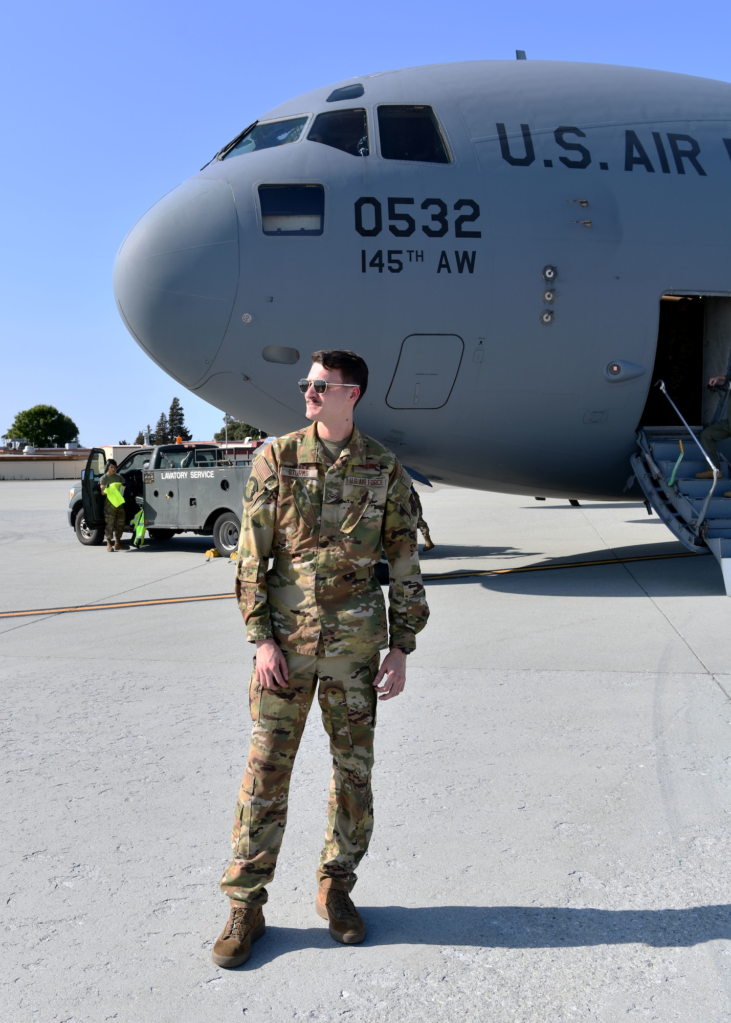 Airman 1st Class Ian Storm, 145th Airlift Wing loadmaster, stands to the side of a C-17 Globemaster III at Travis Air Force Base, California, April 23, 2022. Storm assisted with the transport of 47 Airmen from the 104th Fighter Wing and 174th Attack Wing to Honolulu, Hawaii to complete training at Tripler Army Medical Center. (U.S. Air National Guard Photo by Senior Airman Camille Lienau)