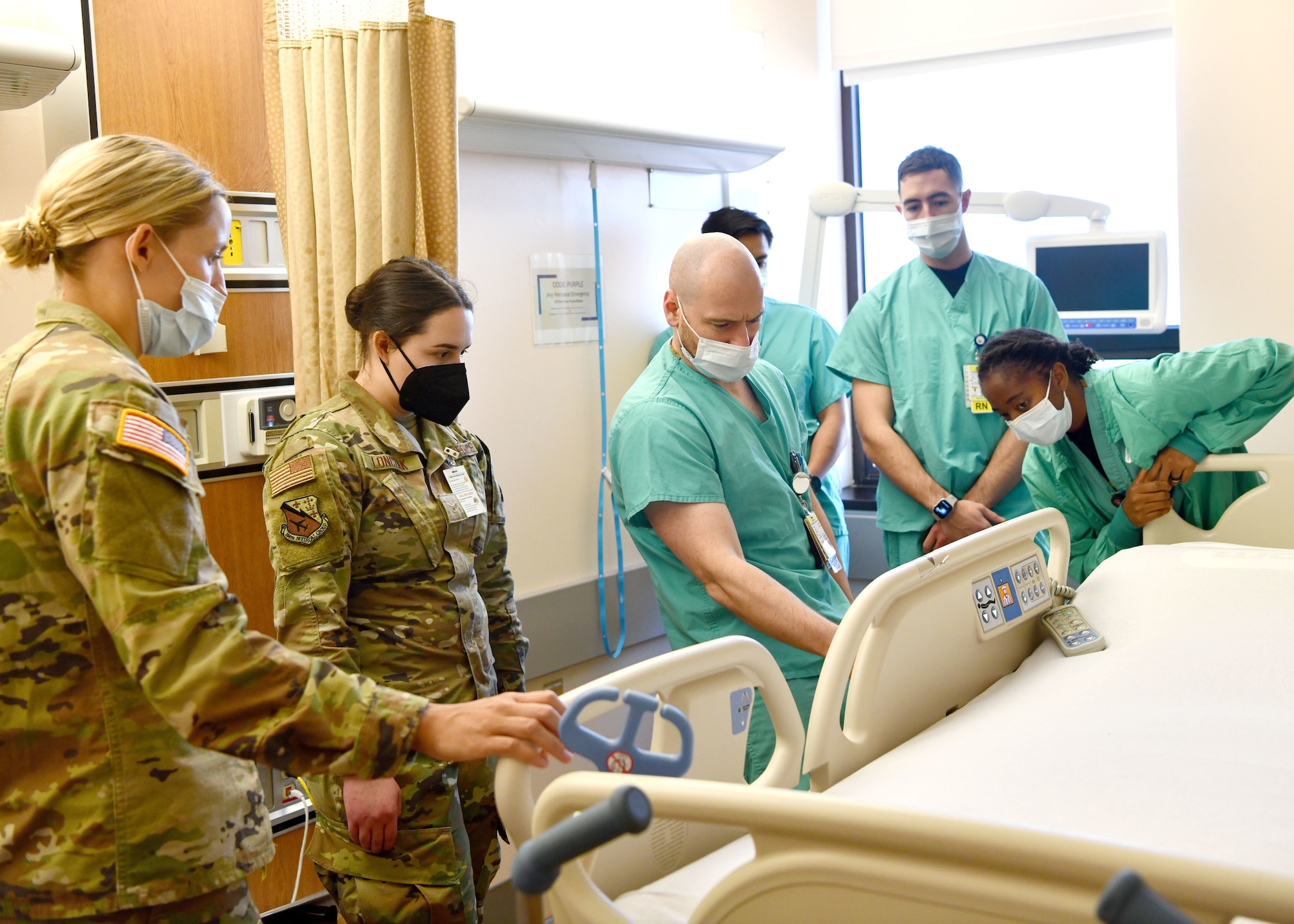 Airman 1st Class Madelyn Lonczak, 104th Medical Group aerospace medical technician and Tripler Army Medical Center staff learn the functions on a hospital bed at TAMC, Hawaii, April 28, 2022. Lonczak is at Tripler to provide medical support and complete training requirements. (U.S. Air National Guard Photo by Senior Airman Camille Lienau)