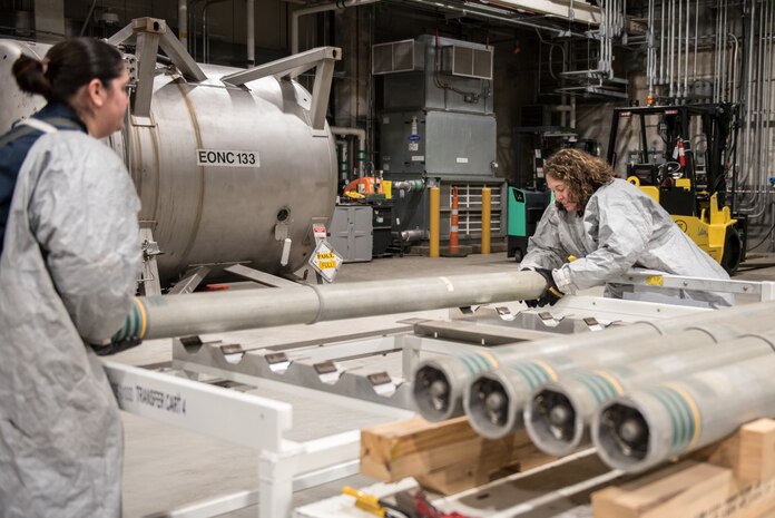 Operators move M55 rockets containing VX nerve agent from a pallet to a transfer cart to begin the destruction process at the Blue Grass Chemical Agent-Destruction Pilot Plant April 15, 2022. (Courtesy photo by Blue Grass Chemical Stockpile Outreach Office)