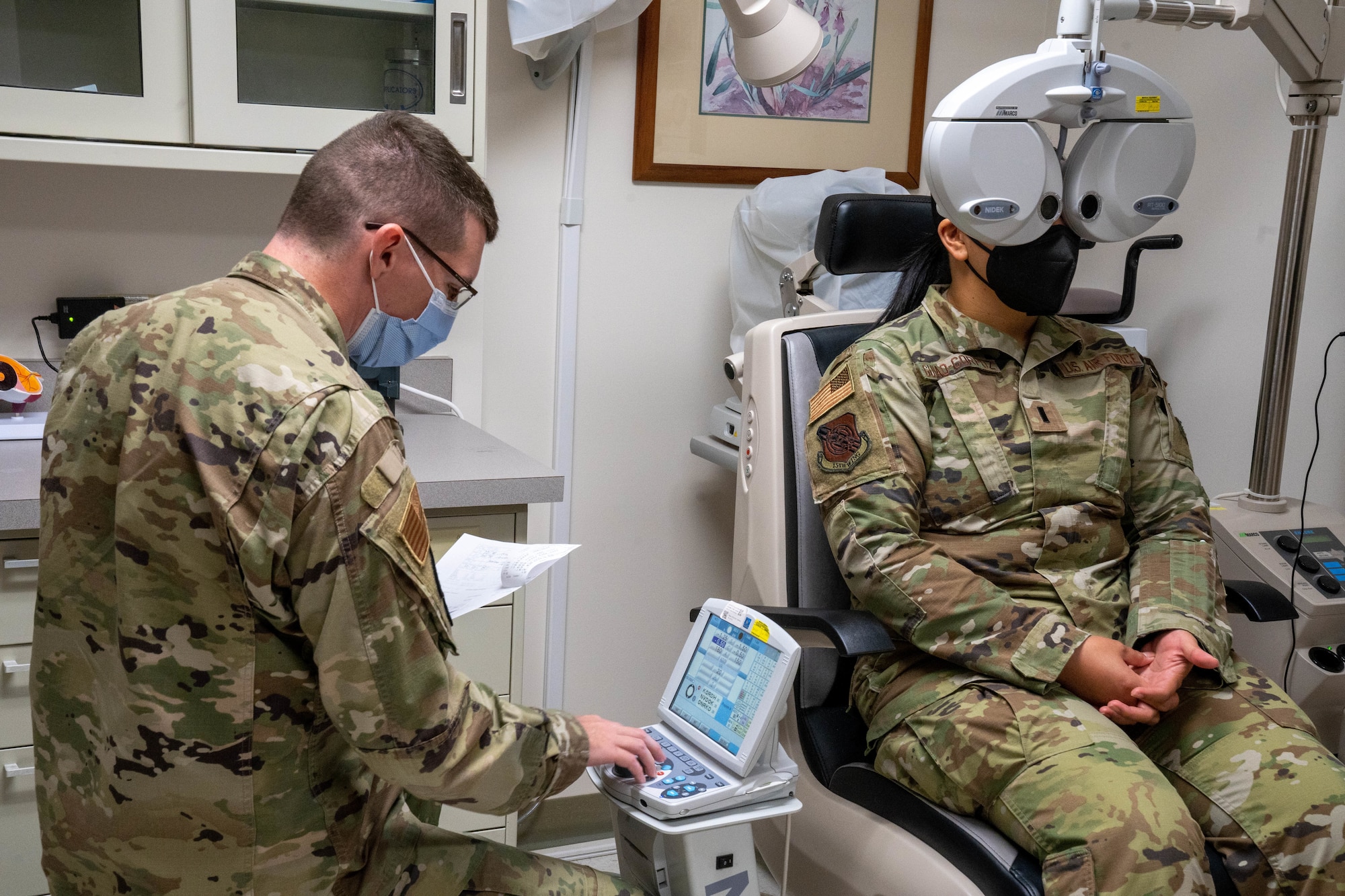 Capt. Dominic Rentz, 15th Operational Medical Readiness Squadron optometrist, conducts an eye exam on 1st Lt. Denise Guiao-Corpuz, 15th Wing Public Affairs chief, at Joint Base Pearl Harbor-Hickam, Hawaii, April 19, 2022. Eye exams help document the eyes by recording the health and changes throughout the years. (U.S. Air Force photo by Airman 1st Class Makensie Cooper)