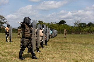 Servicemembers from partner nations participating in Exercise Tradewinds 2022 trains in baton and riot shield training at the Belize Police Academy in Belmopan, Belize on May 9, 2022.