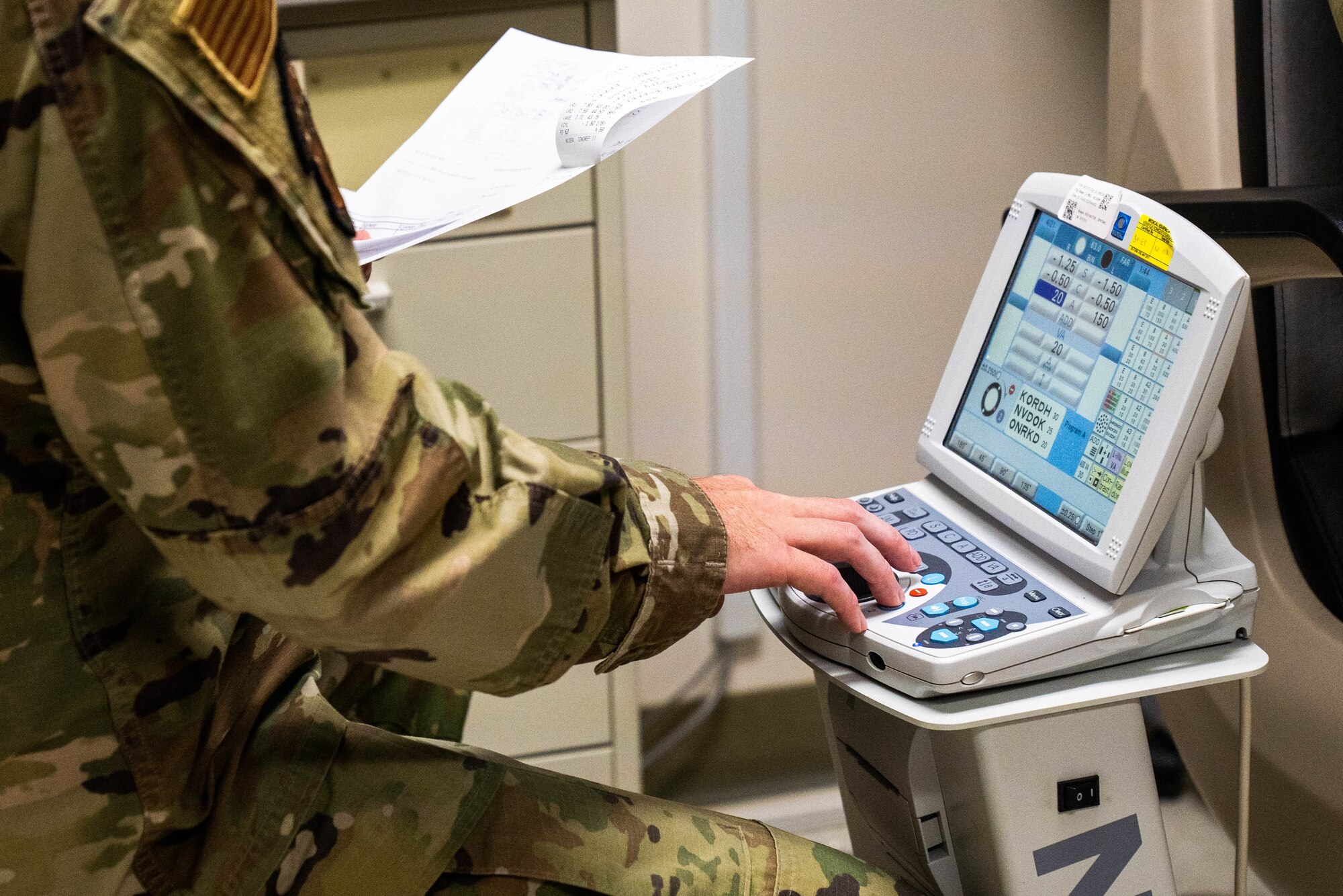 Capt. Dominic Rentz, 15th Operational Medical Readiness Squadron optometrist, operates a phoropter during an eye exam at Joint Base Pearl Harbor-Hickam, Hawaii, April 19, 2022. Eye exams help document the eyes by recording the health and changes throughout the years. (U.S. Air Force photo by Airman 1st Class Makensie Cooper)