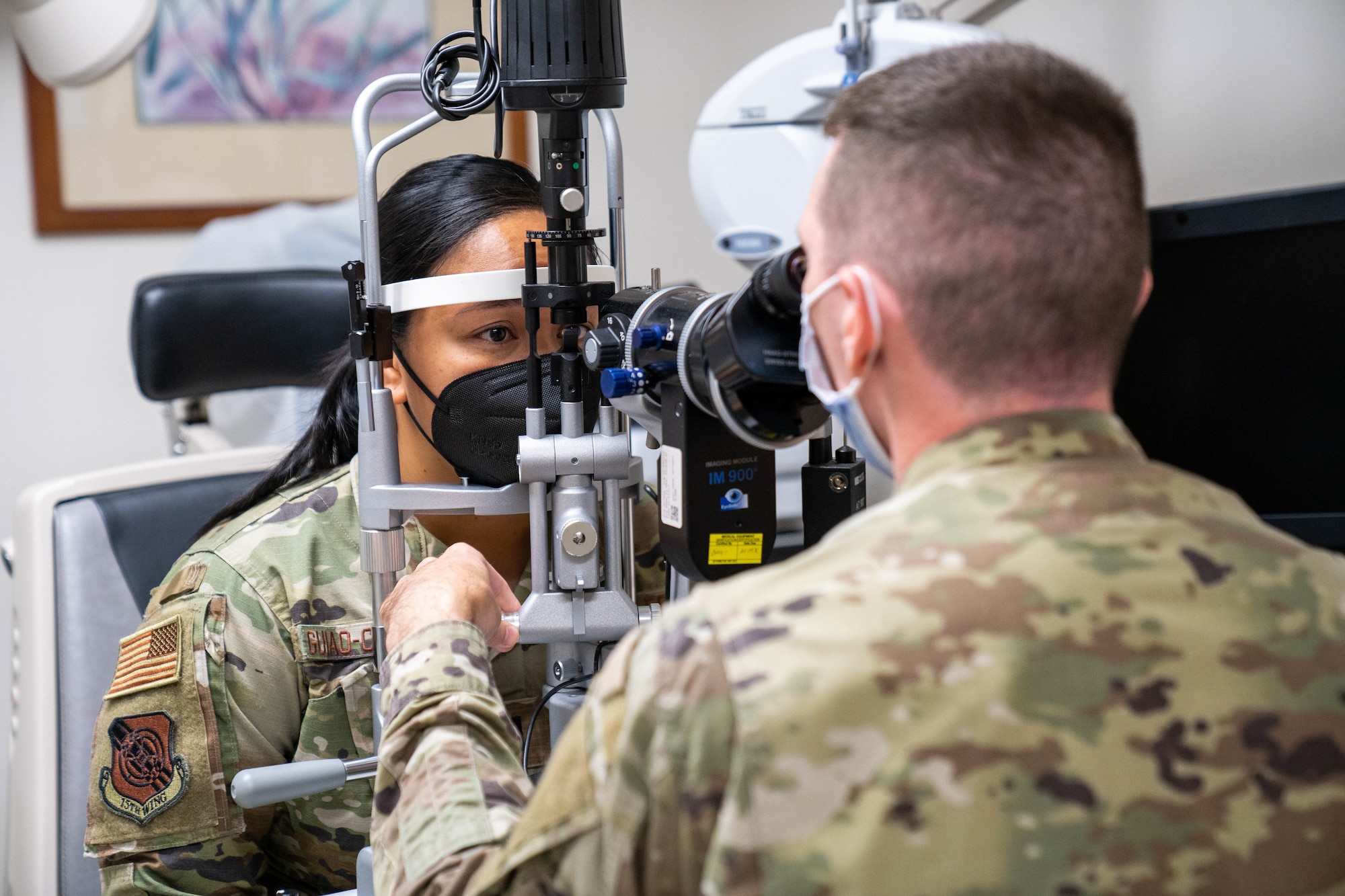 Capt. Dominic Rentz, 15th Operational Medical Readiness Squadron optometrist, examines the eyes of 1st Lt. Denise Guaio-Corpuz, 15th Wing Public Affairs chief, during a routine eye exam at Joint Base Pearl Harbor-Hickam, Hawaii, April 19, 2022. Optometry technicians aid in the diagnosis of eye disorders and help assist Airmen with glasses, while playing an integral part in helping patients with their eye health. (U.S. Air Force photo by Airman 1st Class Makensie Cooper)