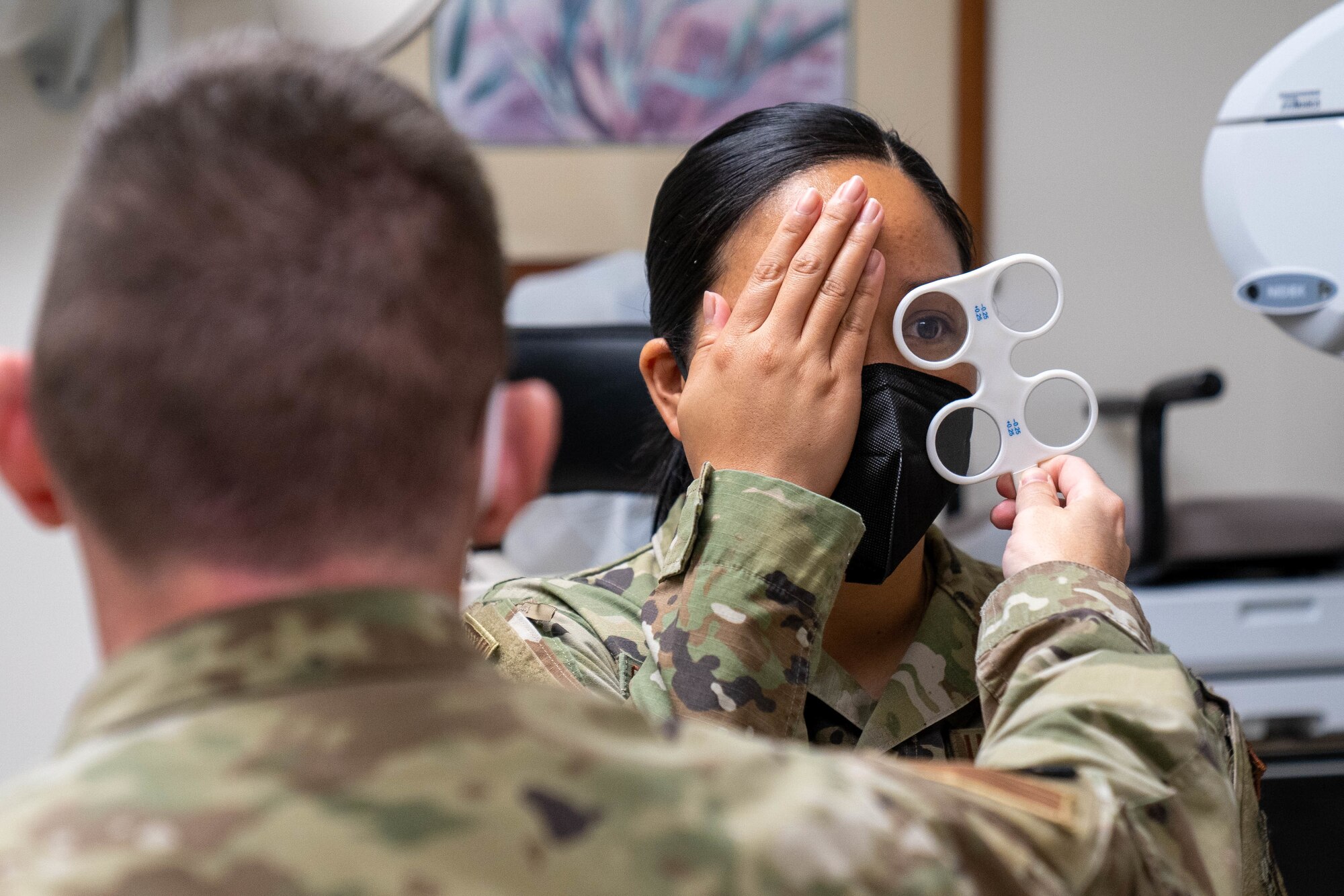 Capt. Dominic Rentz, 15th Operational Medical Readiness Squadron optometrist, examines the eyes of 1st Lt. Denise Guiao-Corpuz, 15th Wing Public Affairs chief, during a routine eye exam at Joint Base Pearl Harbor-Hickam, Hawaii, April 19, 2022. Optometry technicians aid in the diagnosis of eye disorders and help assist Airmen with glasses, while playing an integral part in helping patients with their eye health. (U.S. Air Force photo by Airman 1st Class Makensie Cooper)