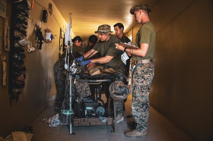 U.S. Navy hospital corpsmen with I Marine Expeditionary Force assess casualty injuries at the Battalion Aid Station during an Expeditionary Medical Integration Course on Camp Pendleton, California May 6, 2022. Expeditionary Operations Training Group conducted EMIC to lay a foundation of skills and knowledge required for MEU medical personnel to provide the highest levels of health service support capability in any operational environment.
