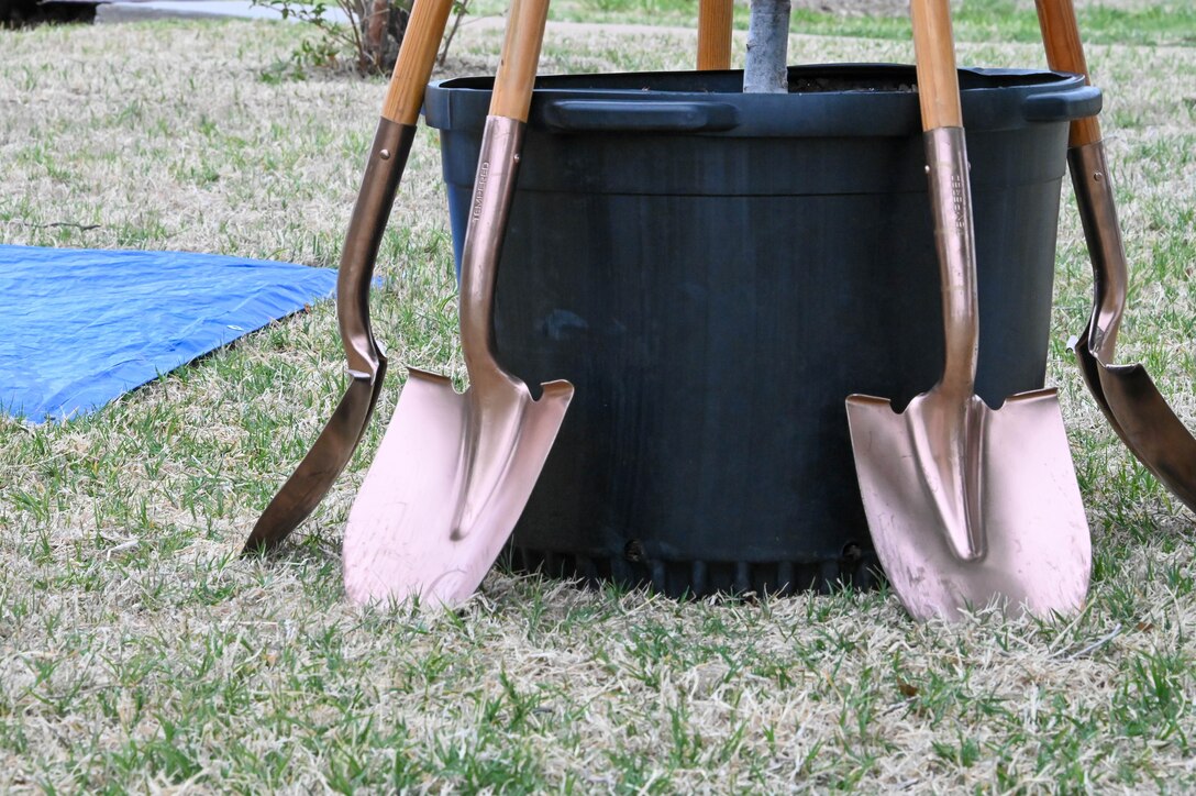 Shovels are propped against an eastern redbud, the Oklahoma state tree, at Altus Air Force Base (AAFB), Oklahoma, May 2, 2022. The tree symbolizes America’s springtime and was chosen because the construction of AAFB started and ended in the spring. (U.S. Air Force photo by Senior Airman Kayla Christenson)