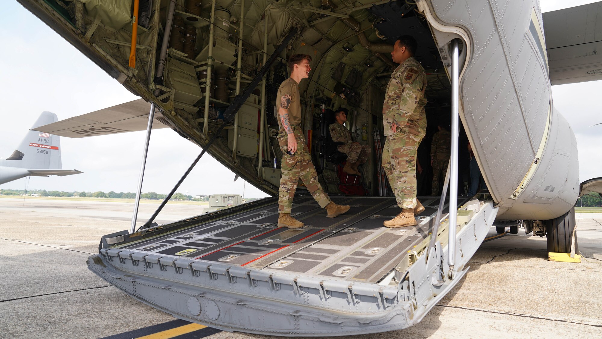 U.S. Air Force Airman Austin St. Clair and Staff Sgt. Timothy Wells, 81st Security Forces Squadron members, tour a C-130 during a joint training with the Biloxi Special Weapons and Tactics team at Keesler Air Force Base, Mississippi, May 9, 2022. Security forces and Biloxi SWAT members trained together on aircraft anti-hijacking procedures.