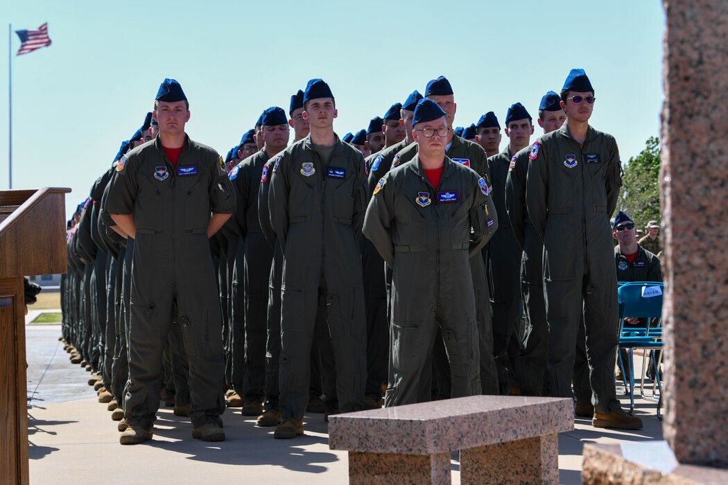 Airmen stand in formation during the 97th Air Mobility Wing’s 42nd Annual Boom Symposium ceremony at Altus Air Force Base, Oklahoma, April 29, 2022. More than 150 active duty, guard, reserve, retired and honorary boom operators from 12 bases and 20 units participated in the symposium. (U.S. Air Force photo by Airman 1st Class Trenton Jancze)