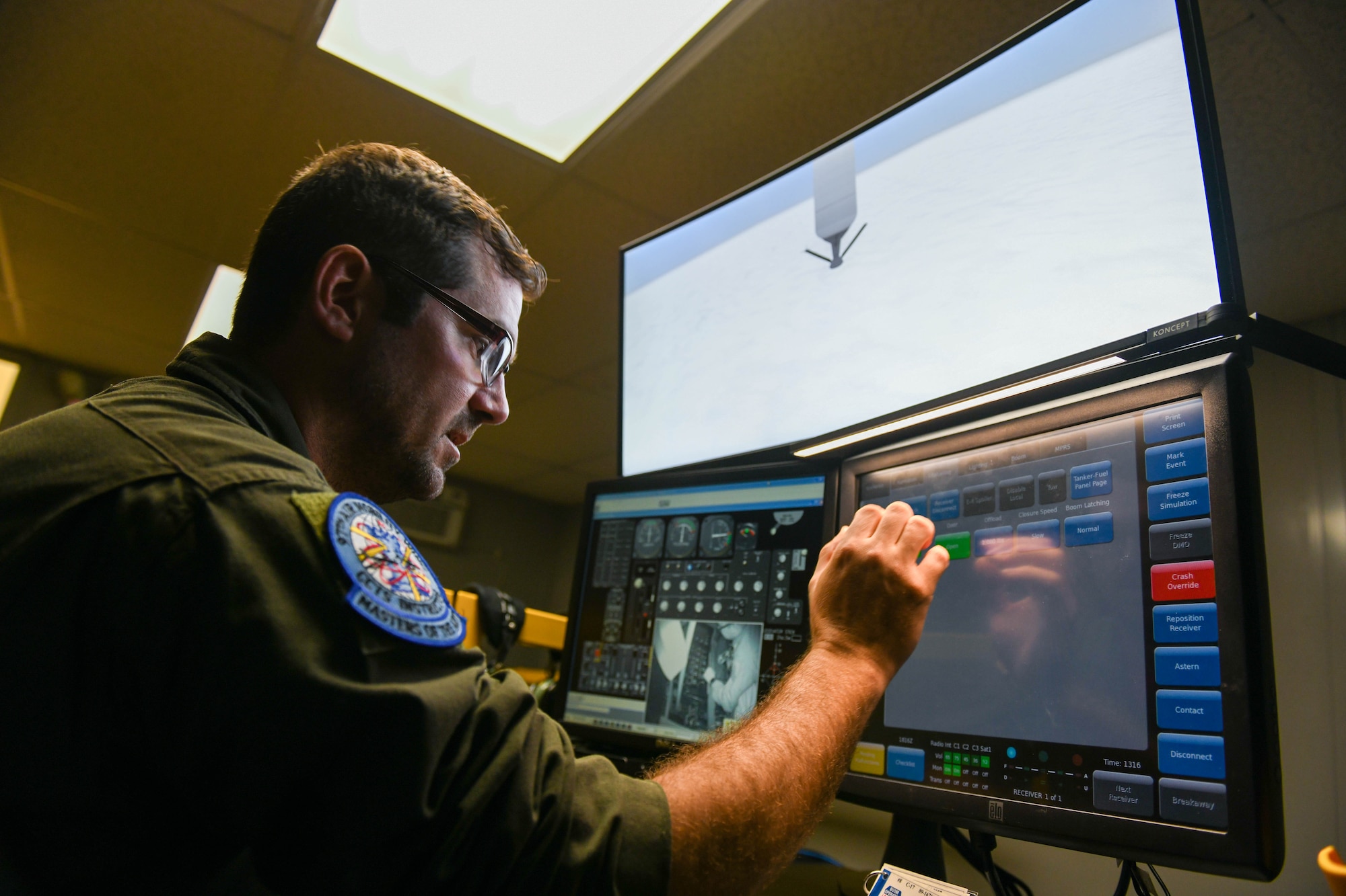 U.S. Air Force Staff Sgt. Jeff Michal, 54th Air Refueling Squadron boom operator instructor, controls a KC-135 Stratotanker boom simulator during the 97th Air Mobility Wing’s 42nd Annual Boom Symposium at Altus Air Force Base, Oklahoma, April 29, 2022. Airmen and families experienced the simulators and other tools utilized during aircrew training. (U.S. Air Force photo by Airman 1st Class Trenton Jancze)