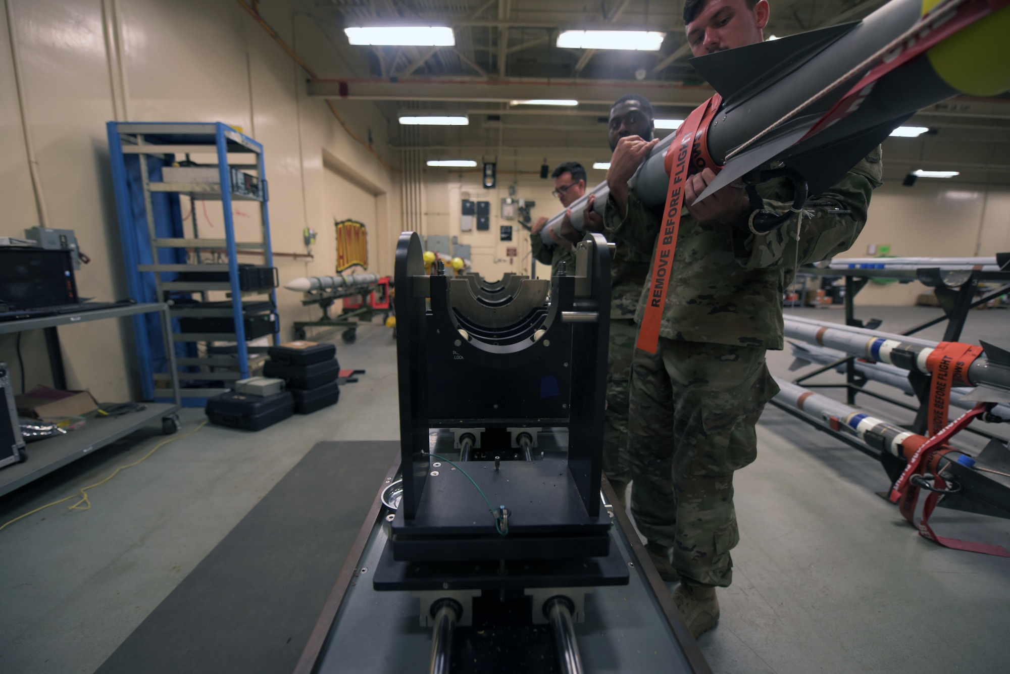 Airmen lift a missile