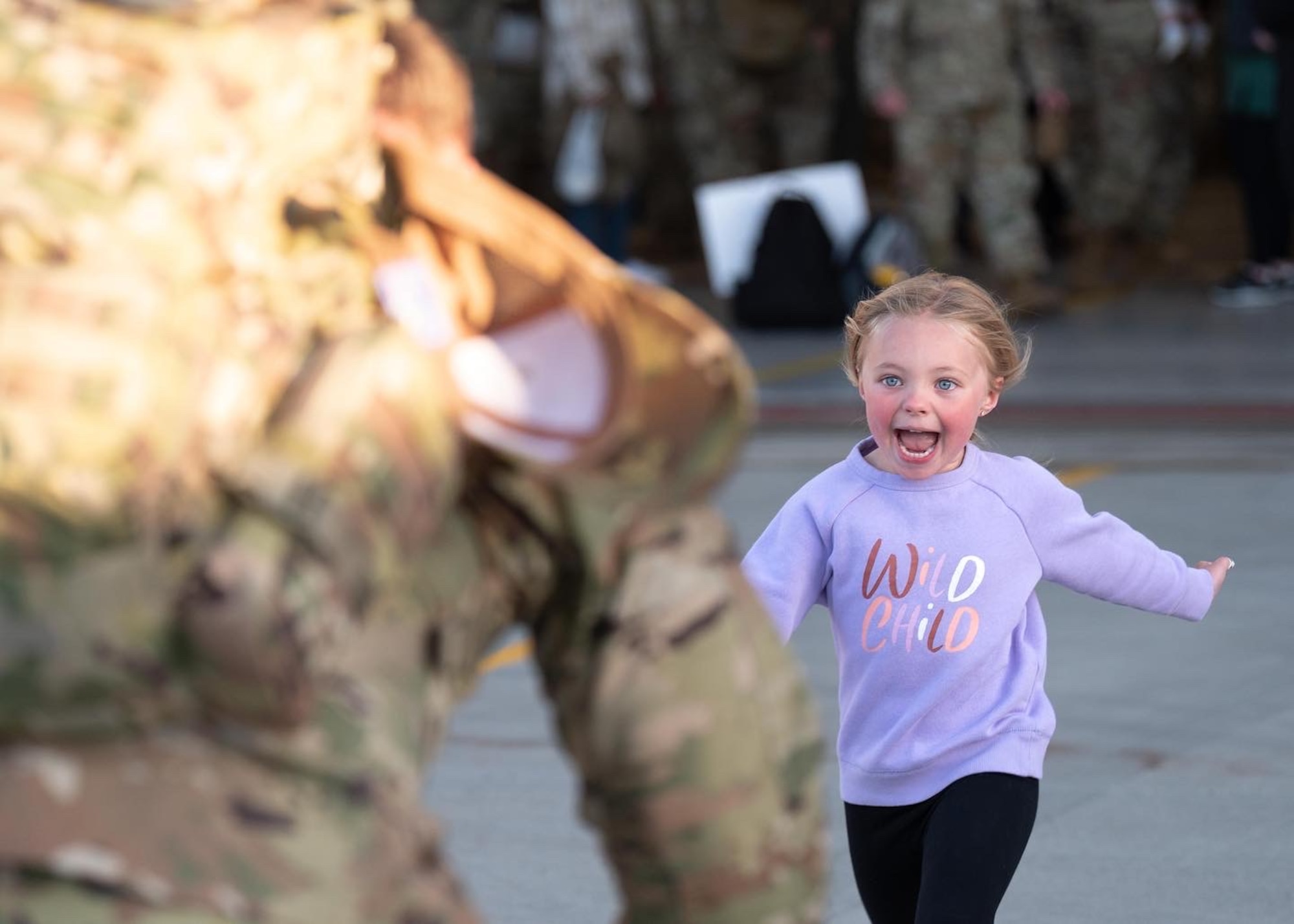 Family members greet Airmen after a deployment.