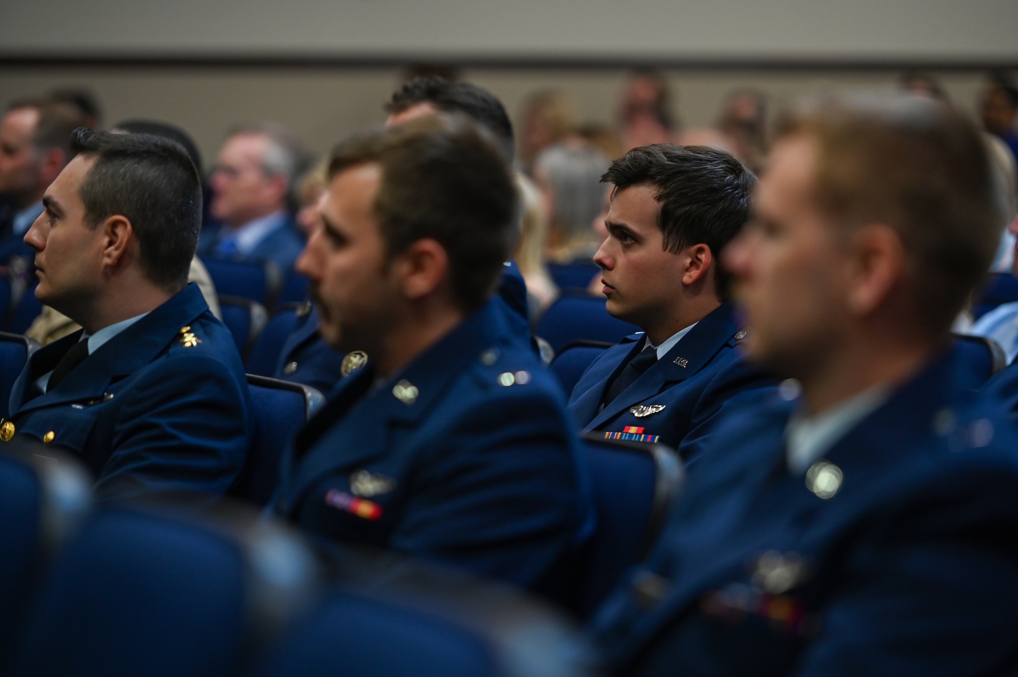 Graduates from Undergraduate Pilot Training Class 22-09 sit at their graduation ceremony on April 6, 2022, at Columbus Air Force Base, Miss. The graduates completed a 52-week pilot training program including academics, physiological training, and flight training in the T-6A Texan II, T-1A Jayhawk, and T-38C Talon. (U.S. Air Force photo by Senior Airman Davis Donaldson)