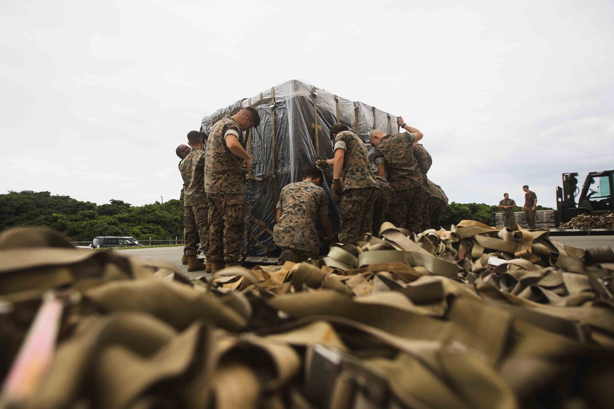 Marines prepare pallets of supplies.