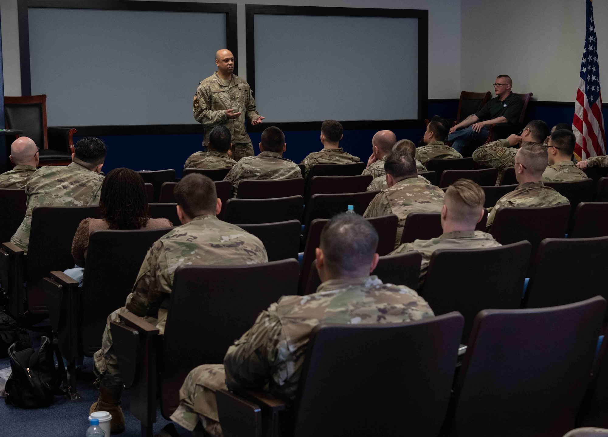 A military member explains the equal opportunity department to other military members.