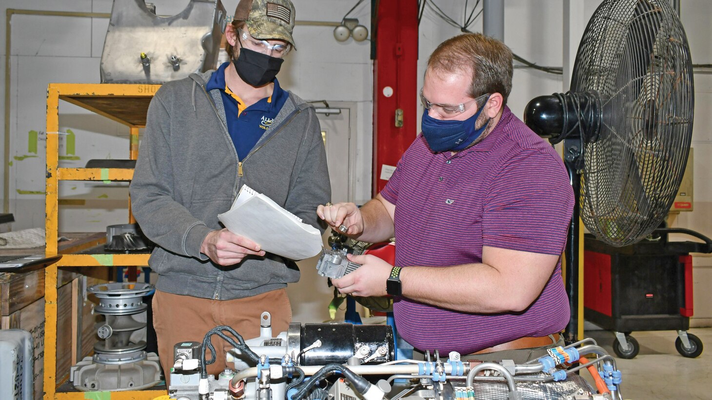 Rob Wansker (right), FRCE V-22 Power and Propulsion Auxiliary Power Unit (APU) senior engineer, and Derek Britton, mechanical engineer in the APU group, examine a clutch servo-valve filter for a V-22 APU. The APU group recently developed a process to clean and recertify these filters for use after supply issues made the critical part temporarily unavailable to the fleet.