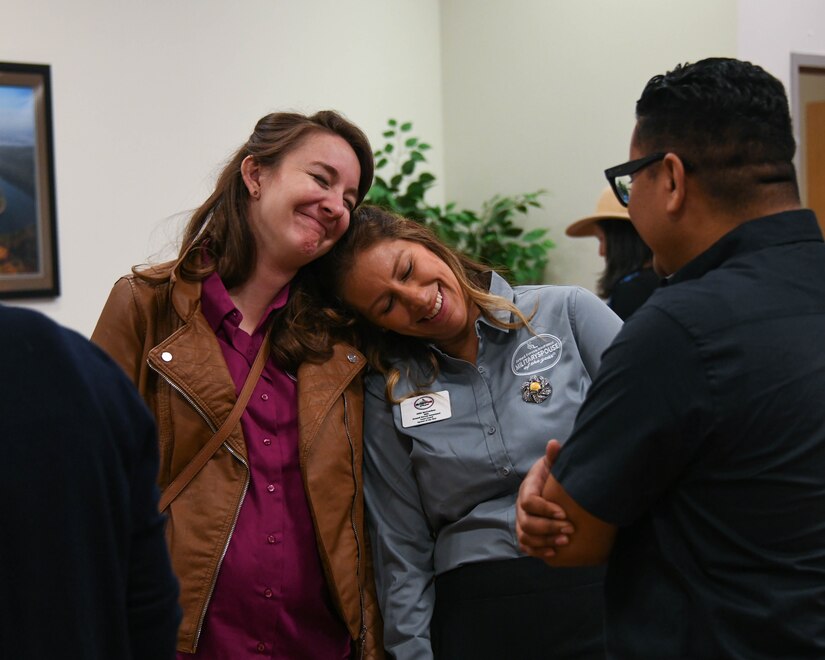 Sarah Streyder and Abi McCracken, both Military Spouses of the Year 2022, greet each other before National Capital Region Military Spouse Appreciation Day at Joint Base Andrews, Md., May 6, 2022. Streyder and McCracken were recognized for their dedication to improving the military lifestyle experience for military families around the NCR. (U.S. Air Force photo by Airman 1st Class Isabelle Churchill)