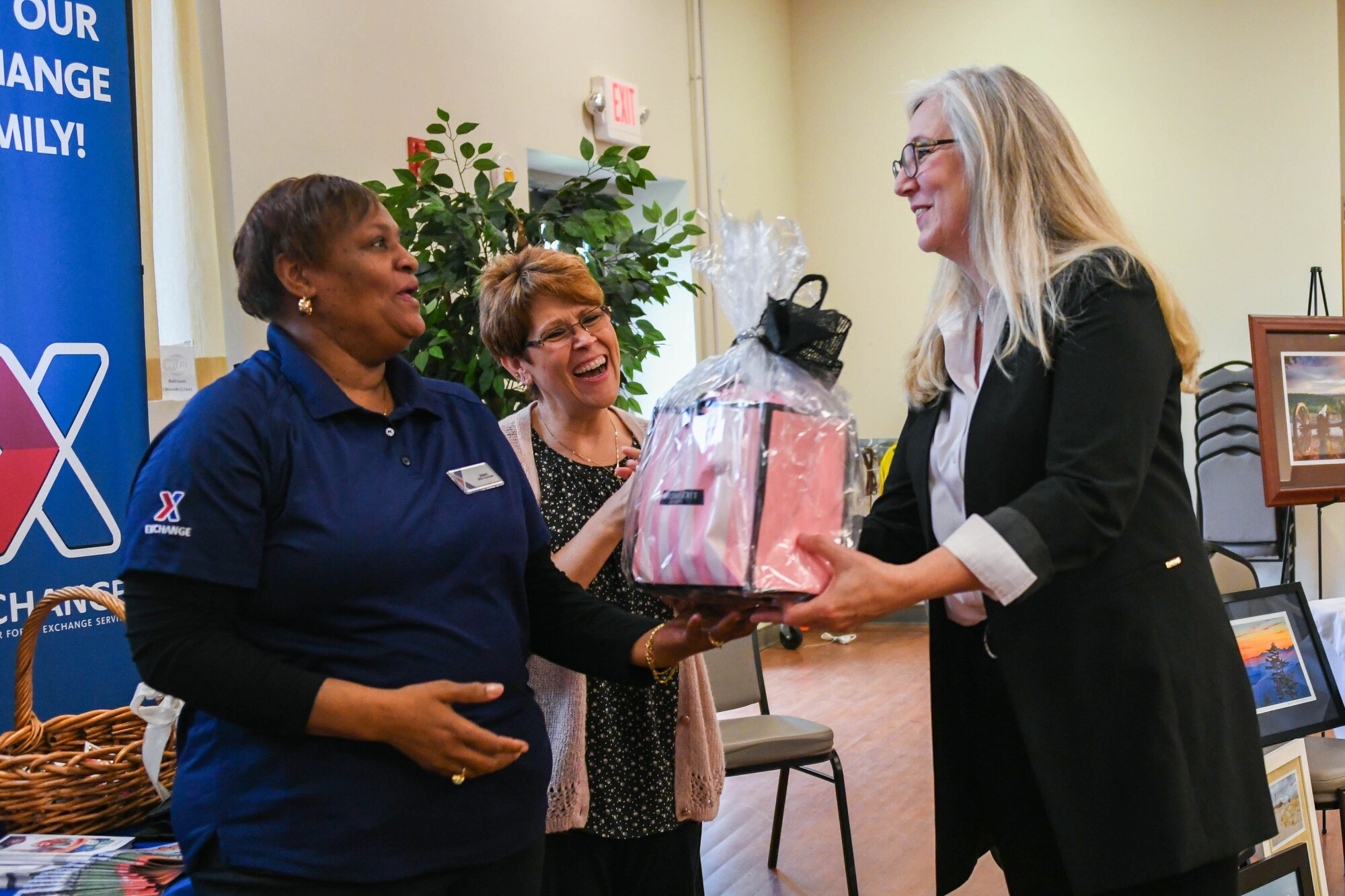 An attendee of the National Capital Region Military Spouse Appreciation Day event receives a gift basket from the Base Exchange at Joint Base Andrews, Md., May 6, 2022. The gift basket was one of many prizes raffled off to show appreciation to military spouses. (U.S. Air Force photo by Airman 1st Class Isabelle Churchill)