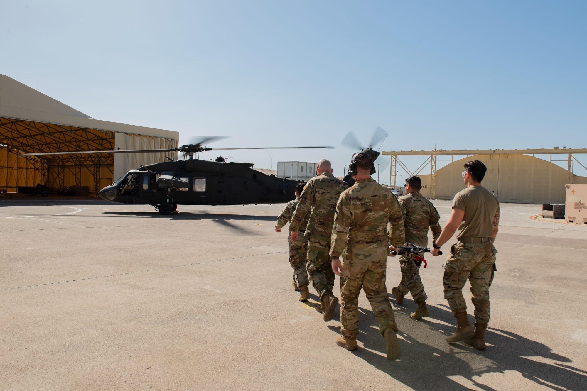 Tactical Combat Casualty Care students from various units across Incirlik Air Base carry a litter to a UH-60 Black Hawk helicopter during the first combined Medic-X and TCCC course hosted by the 39th Medical Group at Incirlik Air Base, Turkey, April 23, 2022. The five-day course integrated multi-capable airman concepts into the existing TCCC curriculum to prepare all medics for prolonged field care. The Air Force Medical Service tasked the 39th MDG to beta test a combined curriculum making this the first training of its kind in the Air Force. (U.S. Air force photo by Staff Sergeant Gabrielle Winn)