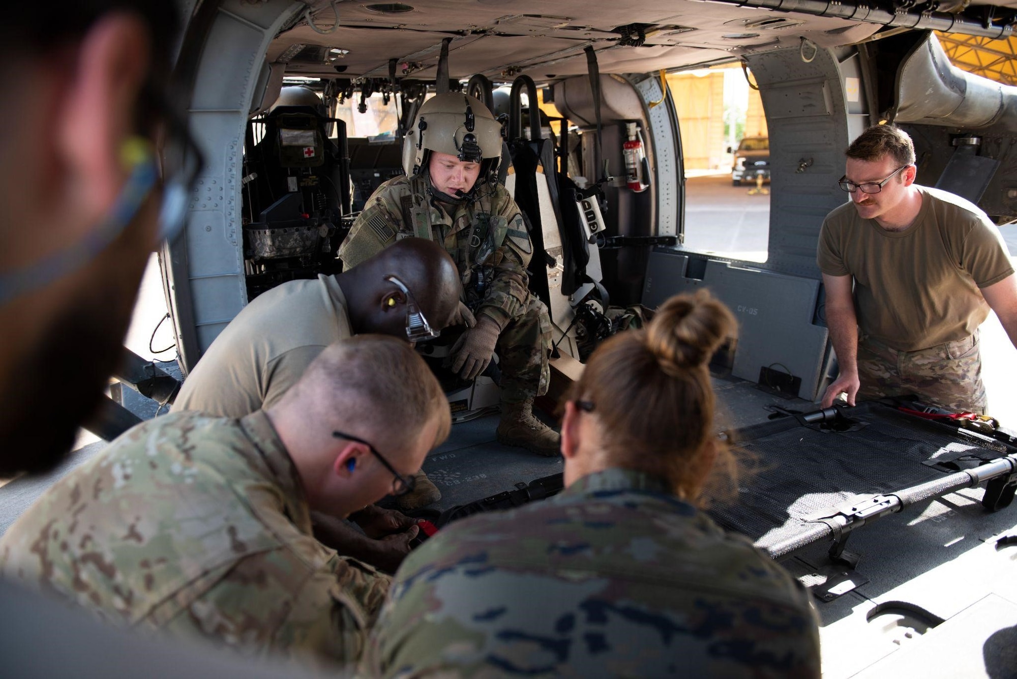 Tactical Combat Casualty Care students fasten a litter to a UH-60 Black Hawk helicopter during the first combined Medic-X and TCCC course hosted by the 39th Medical Group at Incirlik Air Base, Turkey, April 23, 2022. The five-day course integrated multi-capable airman concepts into the existing TCCC curriculum to prepare all medics for prolonged field care. The Air Force Medical Service tasked the 39th MDG to beta test a combined curriculum making this the first training of its kind in the Air Force. (U.S. Air force photo by Staff Sergeant Gabrielle Winn)