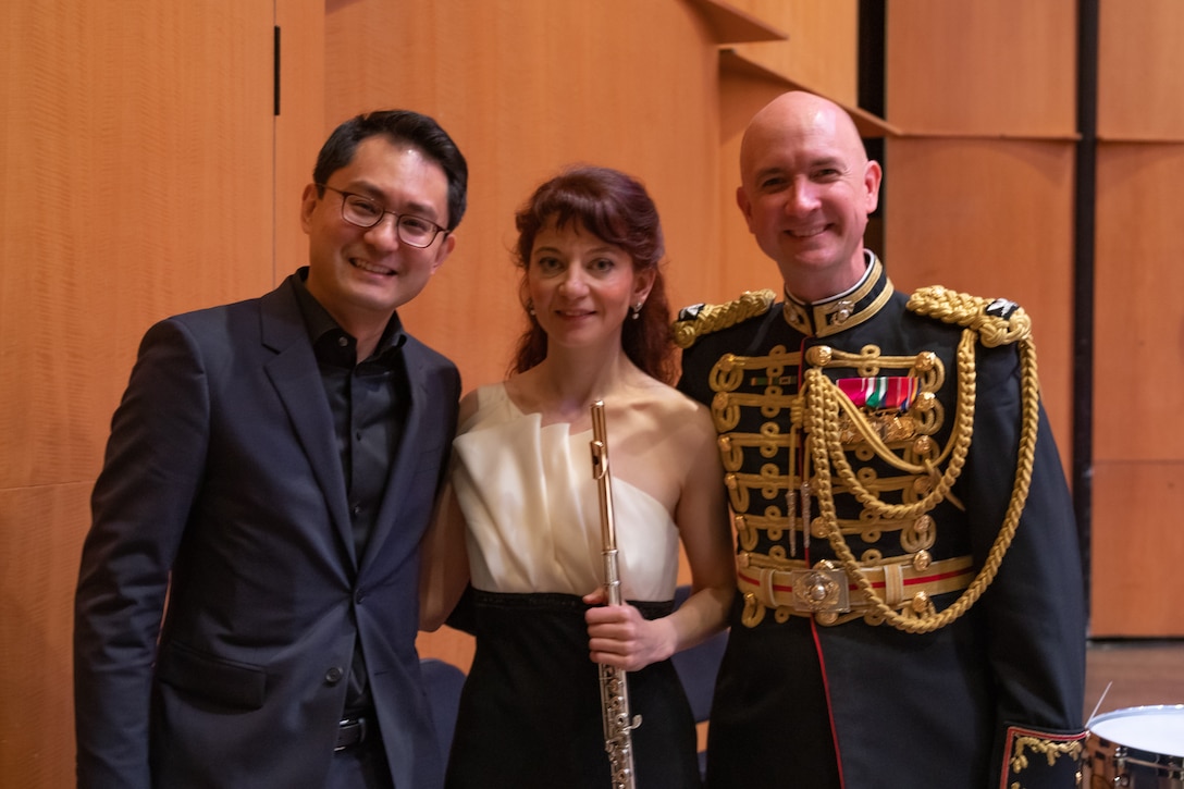 On May 8, 2022, guest soloist Mimi Stillman performed with the Marine Chamber Orchestra at the Rachel M. Schlesinger Concert Hall and Arts Center in Alexandria, Va. During the concert, she gave the world premiere of Concerto for Flute and Orchestra by composer Zhou Tian. Left to right: Zhou Tian, Mimi Stillman, Col. Jason K. Fettig.