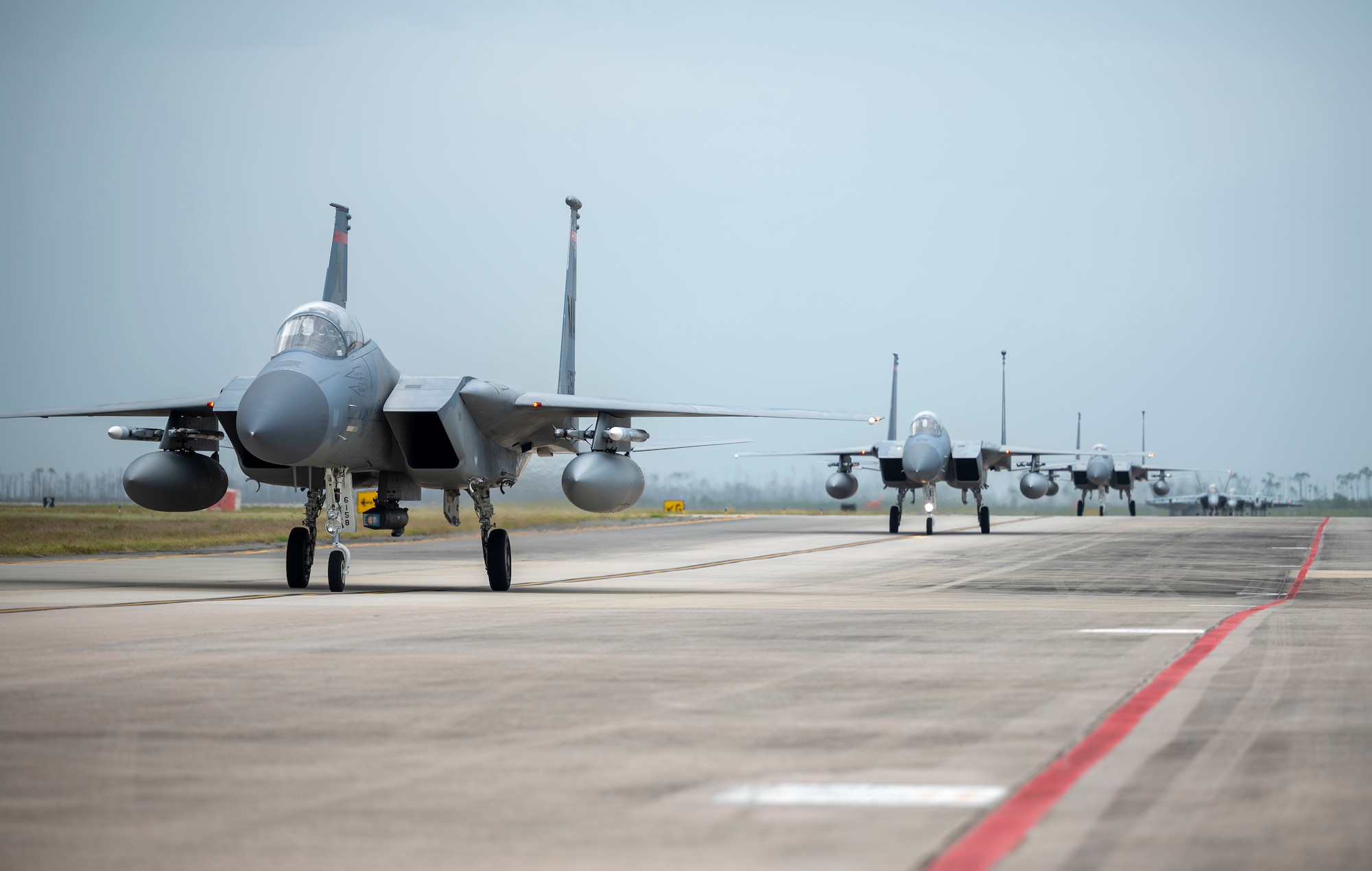F-15C Eagle's taxi down the flight line together