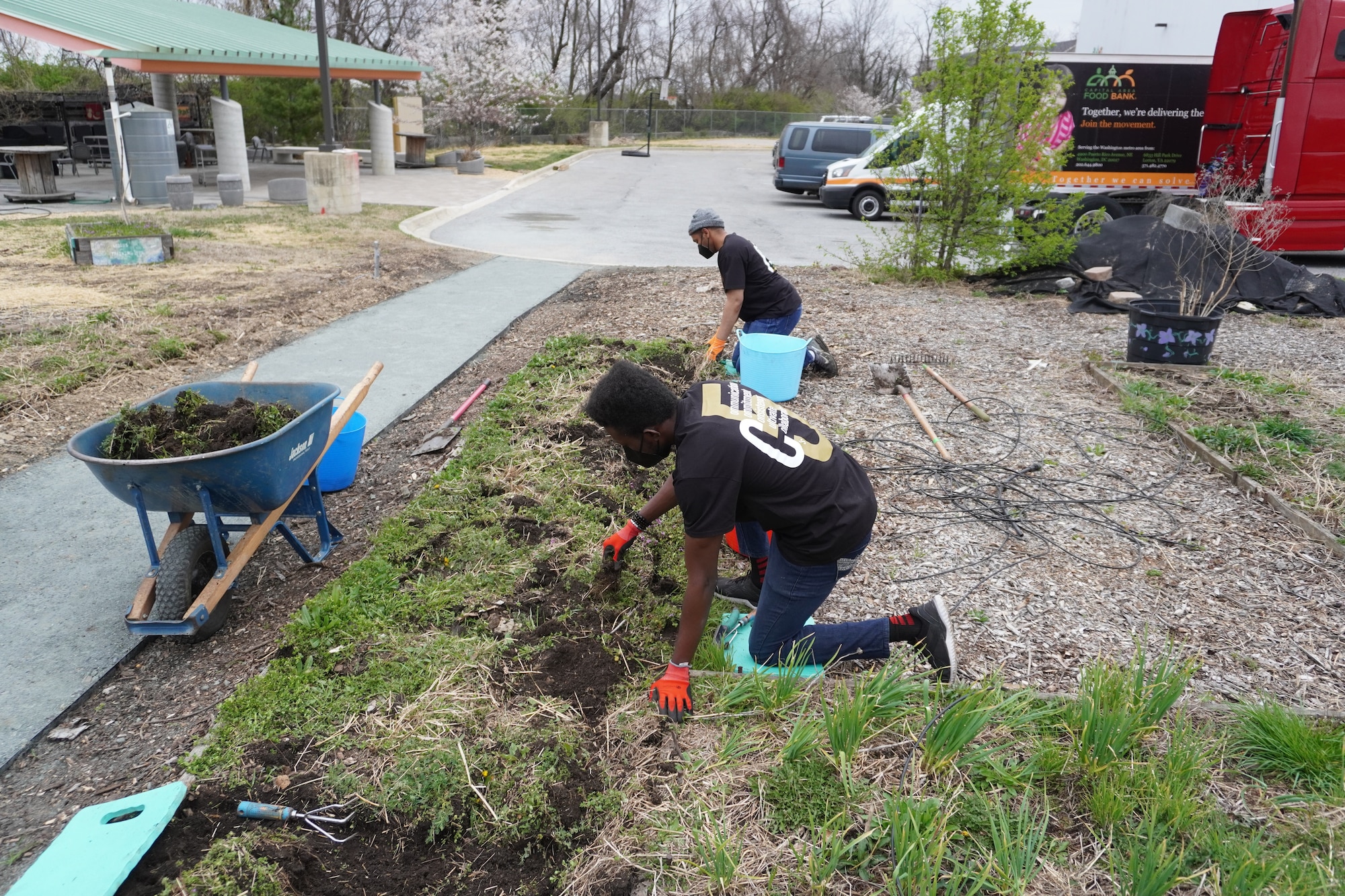 Master Sgt. Michael Glass, 459th Air Refueling Wing, Non-Commissioned Officer in Charge of the wing’s Honor Guard (right), and Senior Airman Marvellous Achugbu of the Honor Guard’s Color Team of The Season, volunteer in the garden of a local area food bank March 23, 2022. The team removed six barrels of weeds from four garden beds used to provide fresh produce to area families with limited access to healthy food. (Courtesy Photo)