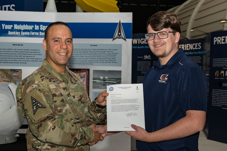 Col. Miguel A. Cruz, Space Delta 4 commander, presents letter