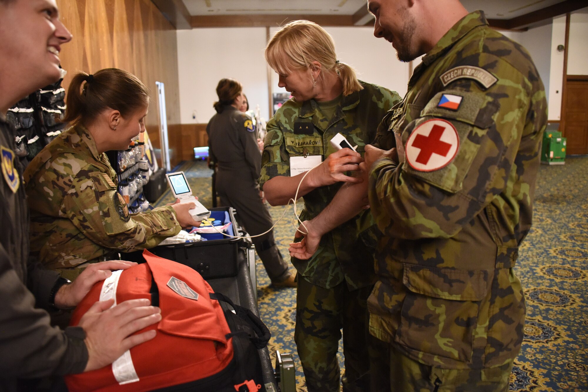 U.S. Air Force Capt. Sarah Juhaz, 10th Air Expeditionary Aeromedical Evacuation Flight critical care nurse, explains the functions and capabilities of the Critical Care Air Transport Team’s portable ultrasound to delegates from the Czech Republic during U.S. Air Forces in Europe - Air Forces Africa’s European-African Military Nursing Exchange conference at Ramstein Air Base, Germany, May 10, 2022.
