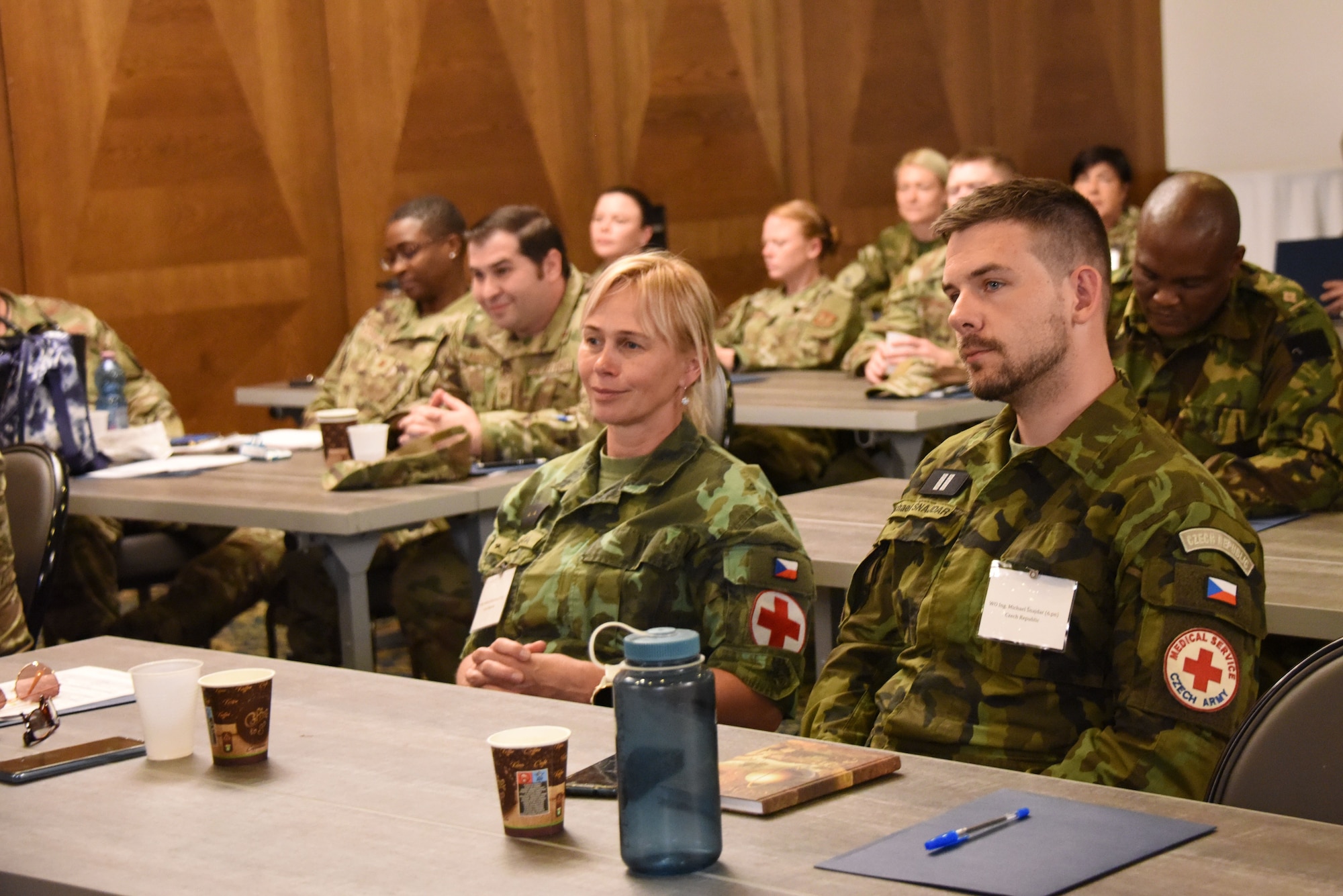 Airmen, Soldiers, and foreign delegates from Botswana, Czech Republic, North Macedonia,  Romania, and Slovenia listen to a talk on “Strength through resilience” during U.S. Air Forces in Europe - Air Forces Africa’s European-African Military Nursing Exchange conference at Ramstein Air Base, Germany, May 9, 2022.