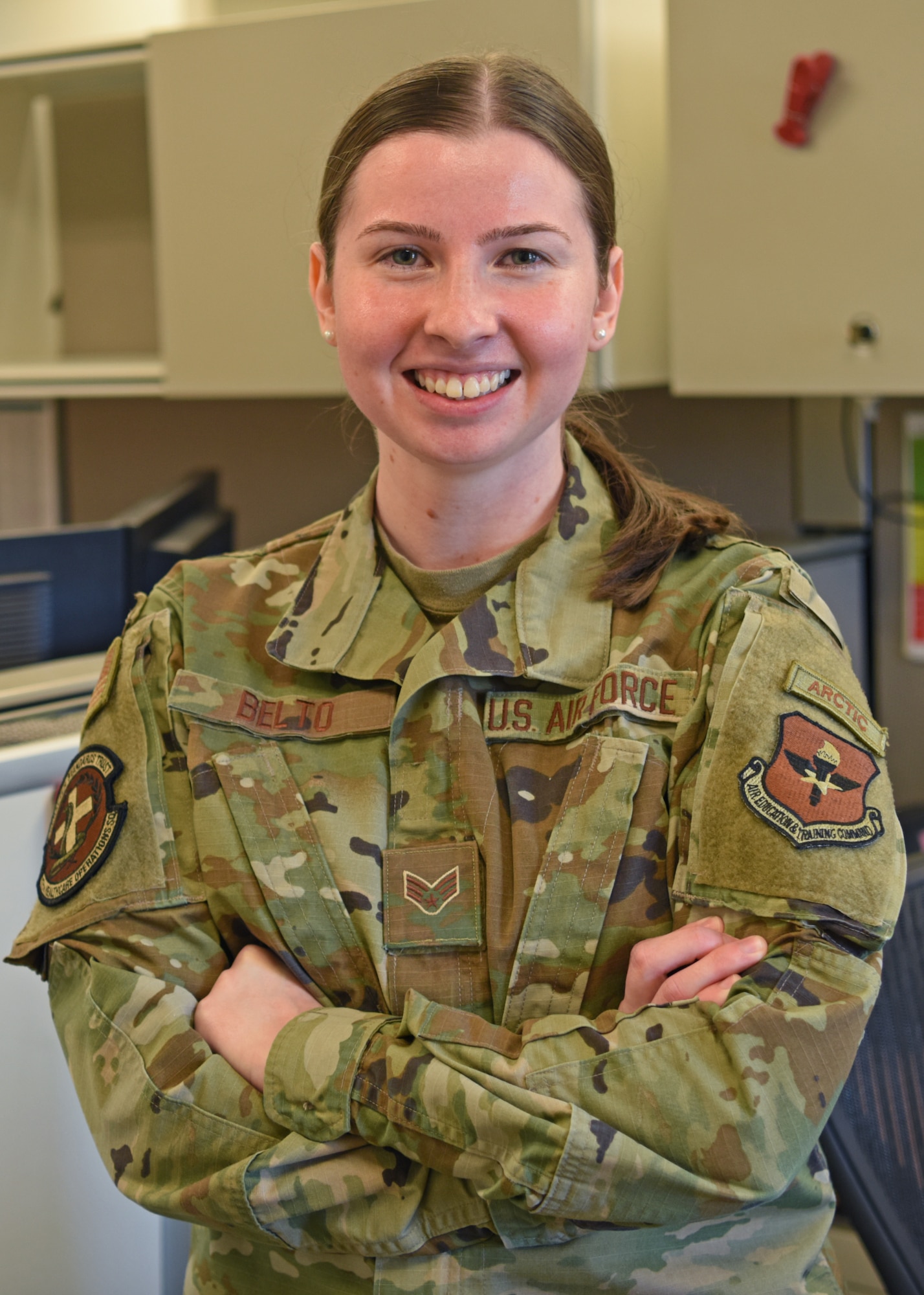 U.S. Air Force Senior Airman Rhiannon Belto, 17th Healthcare Operations Squadron Uniform Business Office manager and manpower technician, poses at the Medical Administration building on Goodfellow Air Force Base, Texas, May 4, 2022. Belto was recognized as the 17th Training Wing Member of the Month for her efforts to support the base. (U.S. Air Force photo by Senior Airman Ethan Sherwood)