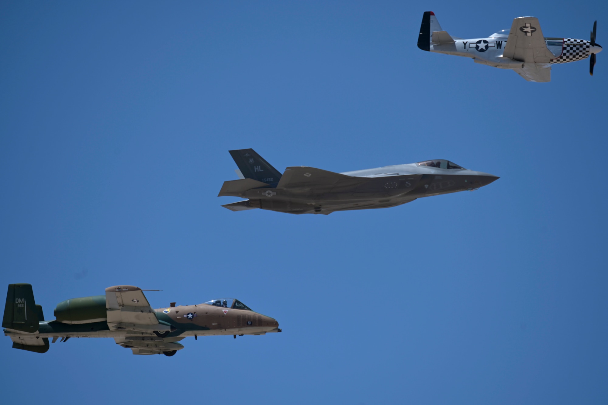 An F-35A Lightning II, from Langley Air Force Base, Virginia; an A-10C Thunderbolt II, from Davis-Monthan Air Force Base, Arizona; and a P-51 Mustang, take flight at the 2022 Holloman Legacy of Liberty Air Show and Open House, May 7, 2022, on Holloman Air Force Base, New Mexico. The aircraft took part in a Heritage flight that paid homage to various generations and the fighter aircraft that embodied the standard for that time. (U.S. Air Force photo by Airman 1st Class Antonio Salfran)