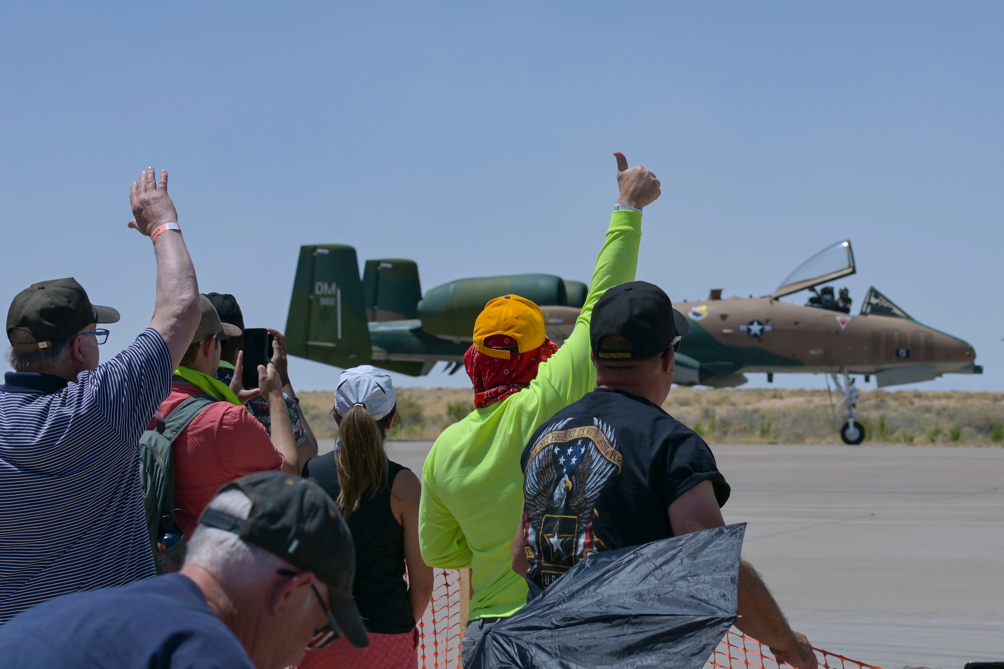 Spectators cheer as the A-10C Thunderbolt II, from Davis-Monthan Air Force Base, Arizona, taxis during the 2022 Holloman Legacy of Liberty Air Show and Open House May 7, 2022, Holloman Air Force Base, New Mexico. The A-10C Thunderbolt II Demonstration Team performed during the event showcasing its power and capabilities. (U.S. Air Force photo by Airman 1st Class Antonio Salfran)